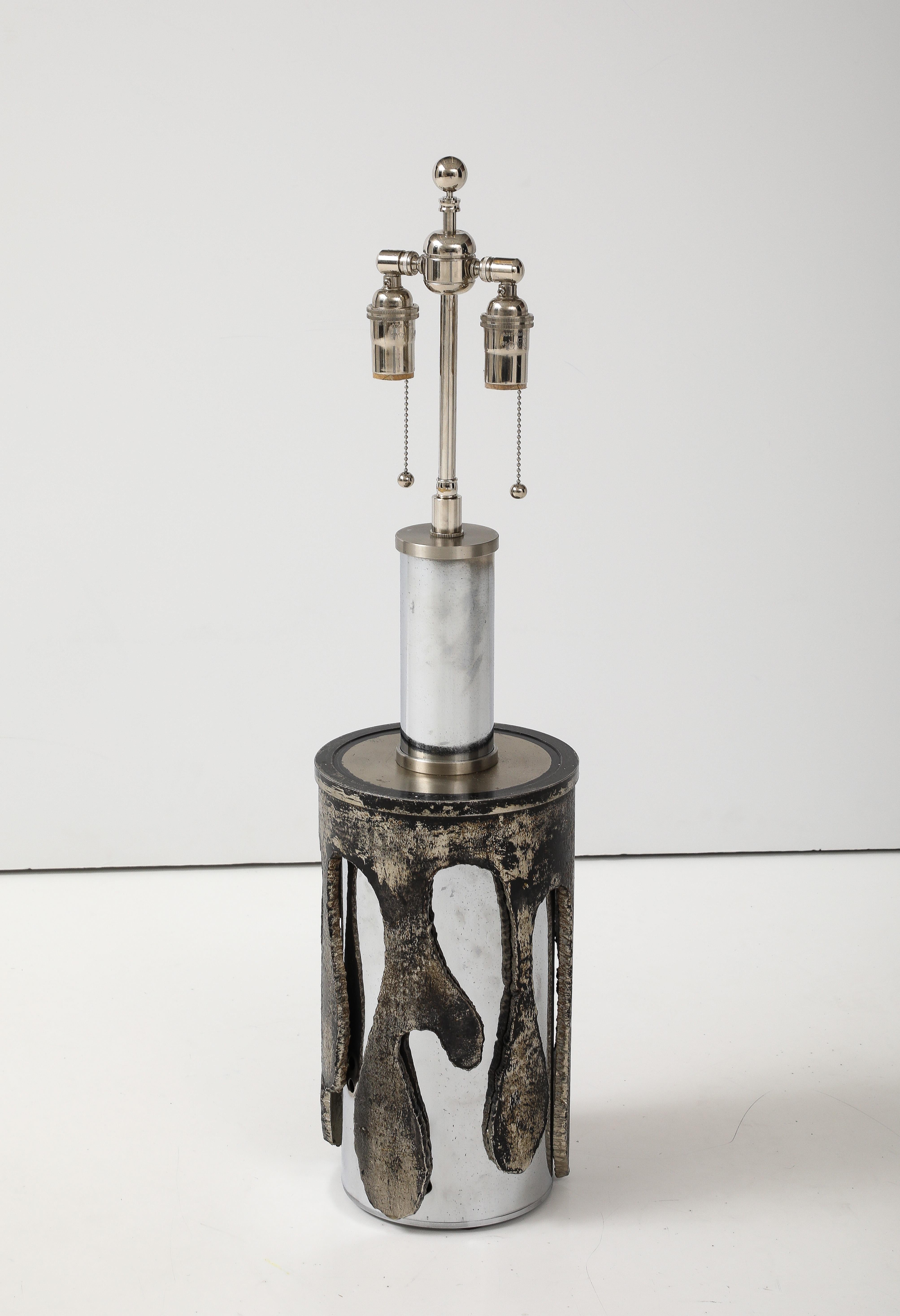 Italian 1970's  Brutalist  lamp designed by Banci Firenze.
The torch cut drip form steel design overlays a polished Stainless steel column and has been Newly 
rewired with an adjustable polished Nickel double cluster that takes standard size light