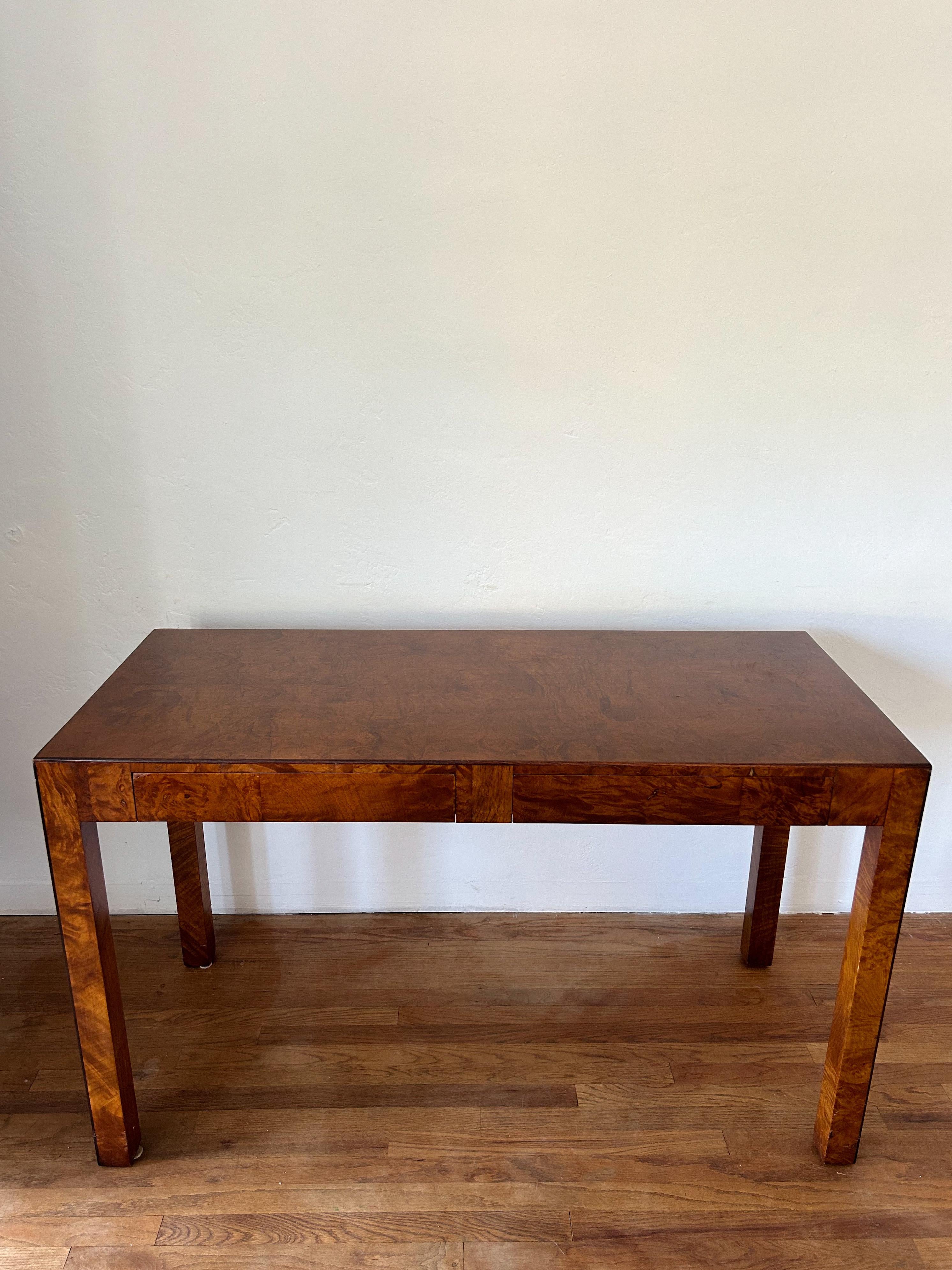 Vintage Burl wood console table or writing desk in the style of John Widdicomb. Console comes with two drawers and features parsons style legs.