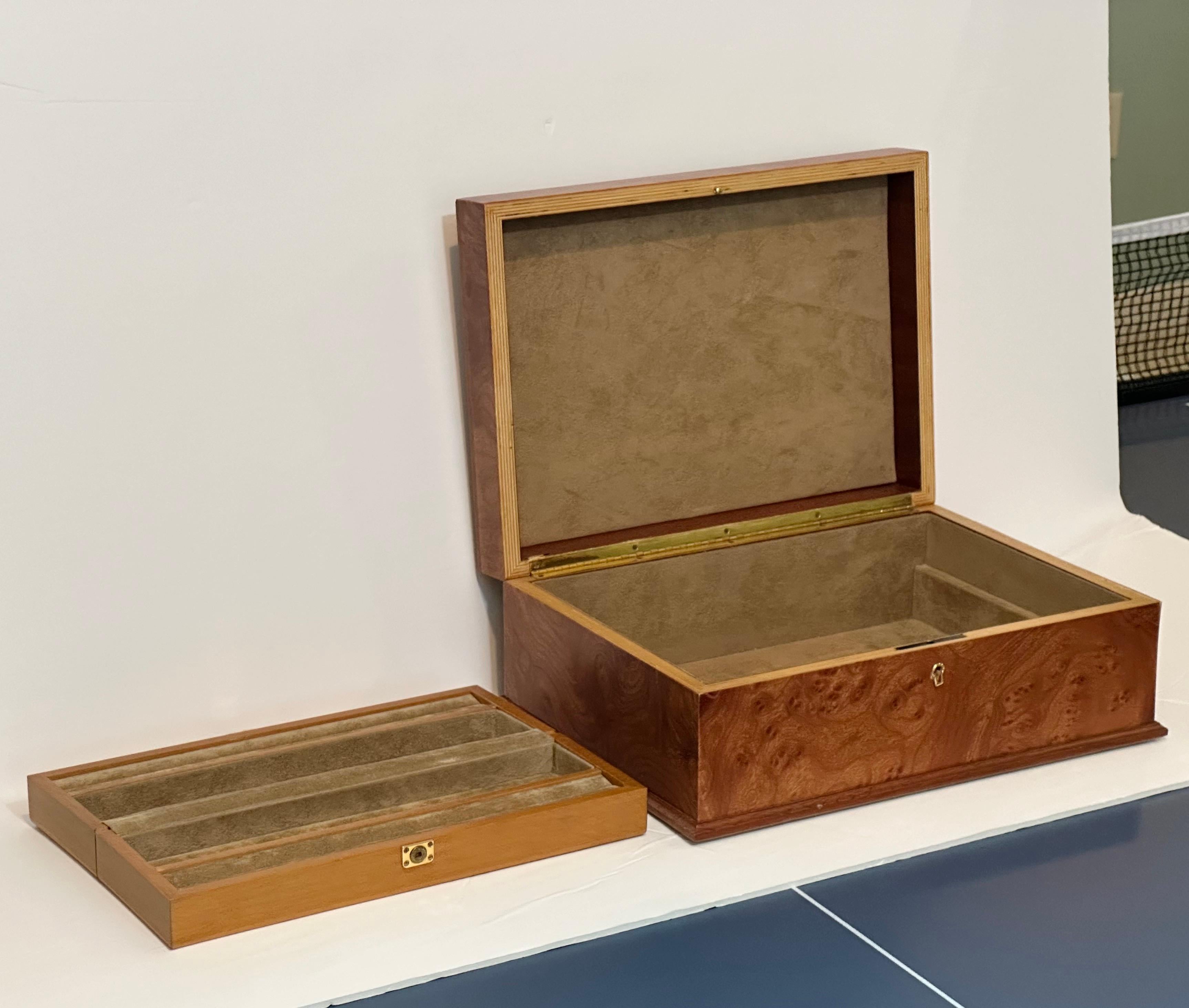 We are very pleased to offer a delightful burlwood jewelry box, circa the 1970s. Crafted with care, it serves as both a functional storage solution and a visually appealing piece.  As you lift the lid, you'll discover a well-designed interior that