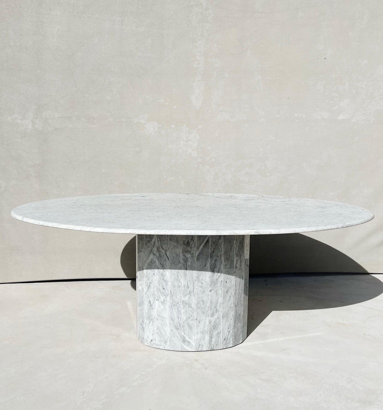 1970s Italian Carrara marble oval dining table with fluted base

An elegant Italian vintage oval dining table, designed and crafted in the 1970s

This dining table showcases an oval cut top with soft rounded edges, a perfectly fluted oval base and