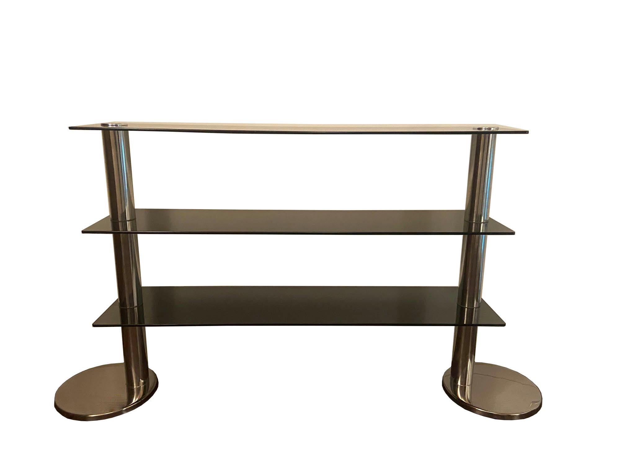A chrome and glass console table or TV and entertainment stand with three shelves and rounded chrome bases. Very well-made and stabile a great design from the period and ready for a number of application.