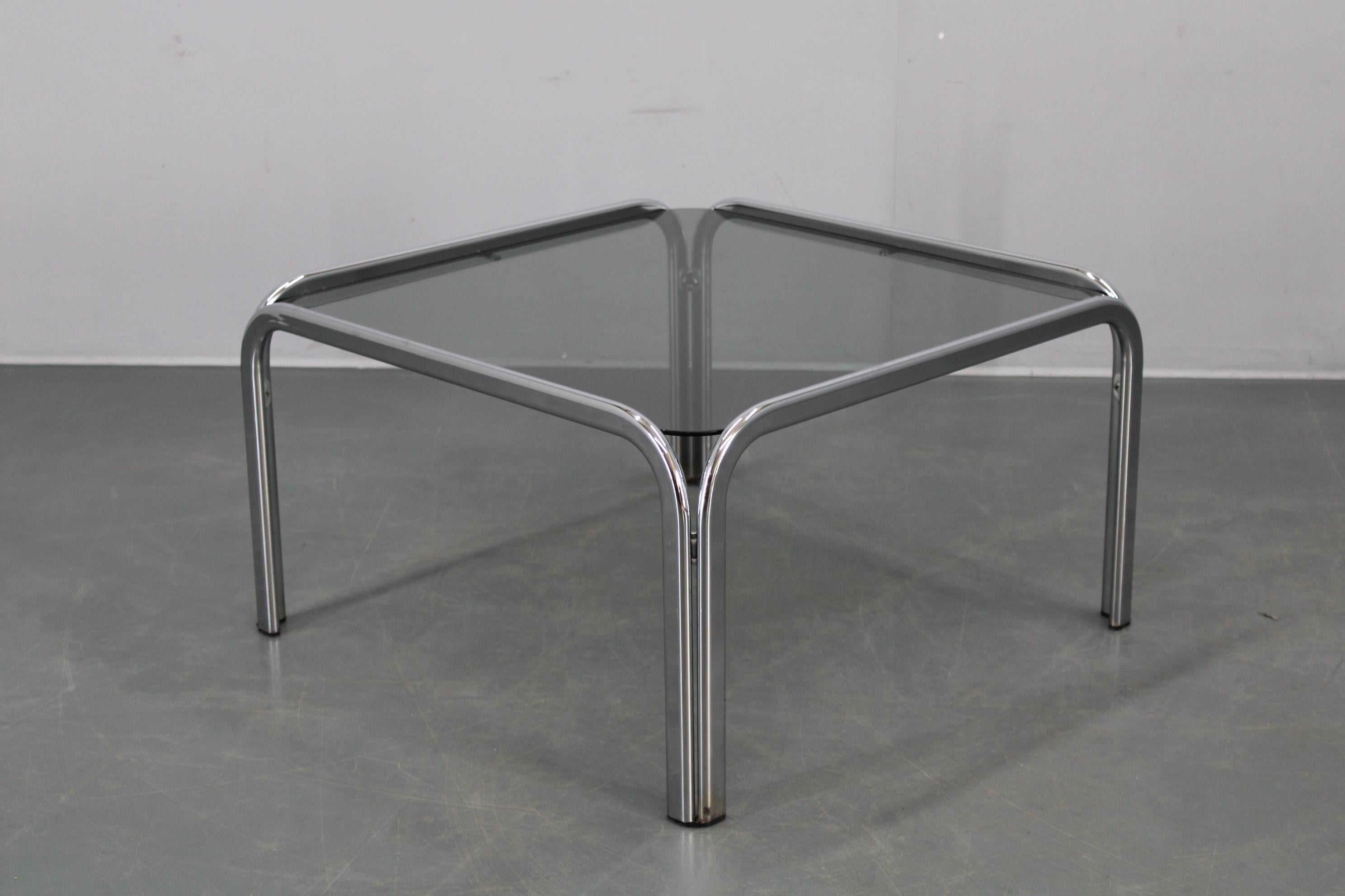 Coffee table made in Italy in the 1970s, featuring a chrome-plated metal frame and a glass top with softly rounded corners for a refined modernist silhouette. This piece is perfect for contemporary or vintage-inspired spaces needing a bright,