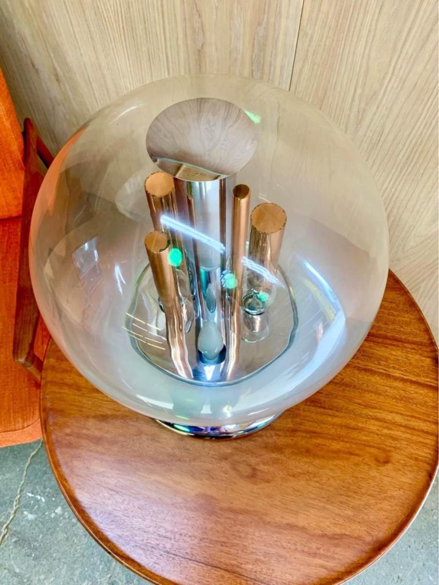 We are thrilled to present this unique table lamp by Selenova, crafted in the 1970s. It features a thick milky glass shade paired with copper and chrome cylinders, creating a distinctly futuristic, space-age aesthetic. Remarkably well-preserved, the