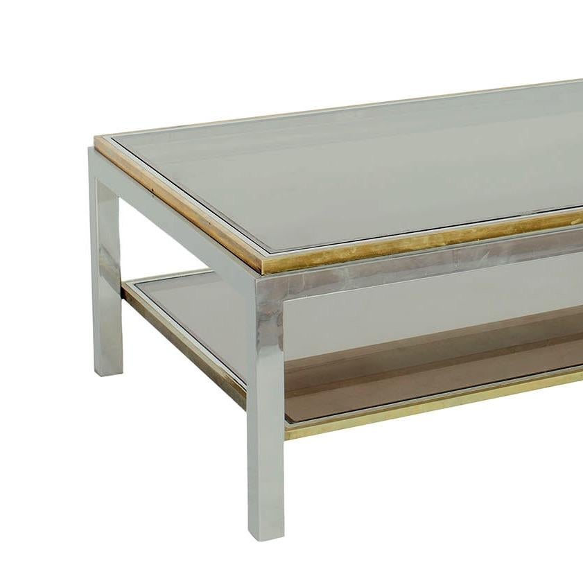 This 1970s Italian rectangular chrome and brass coffee table by Willy Rizzo includes a smoked glass top. 

Since Schumacher was founded in 1889, our family-owned company has been synonymous with style, taste, and innovation. A passion for luxury