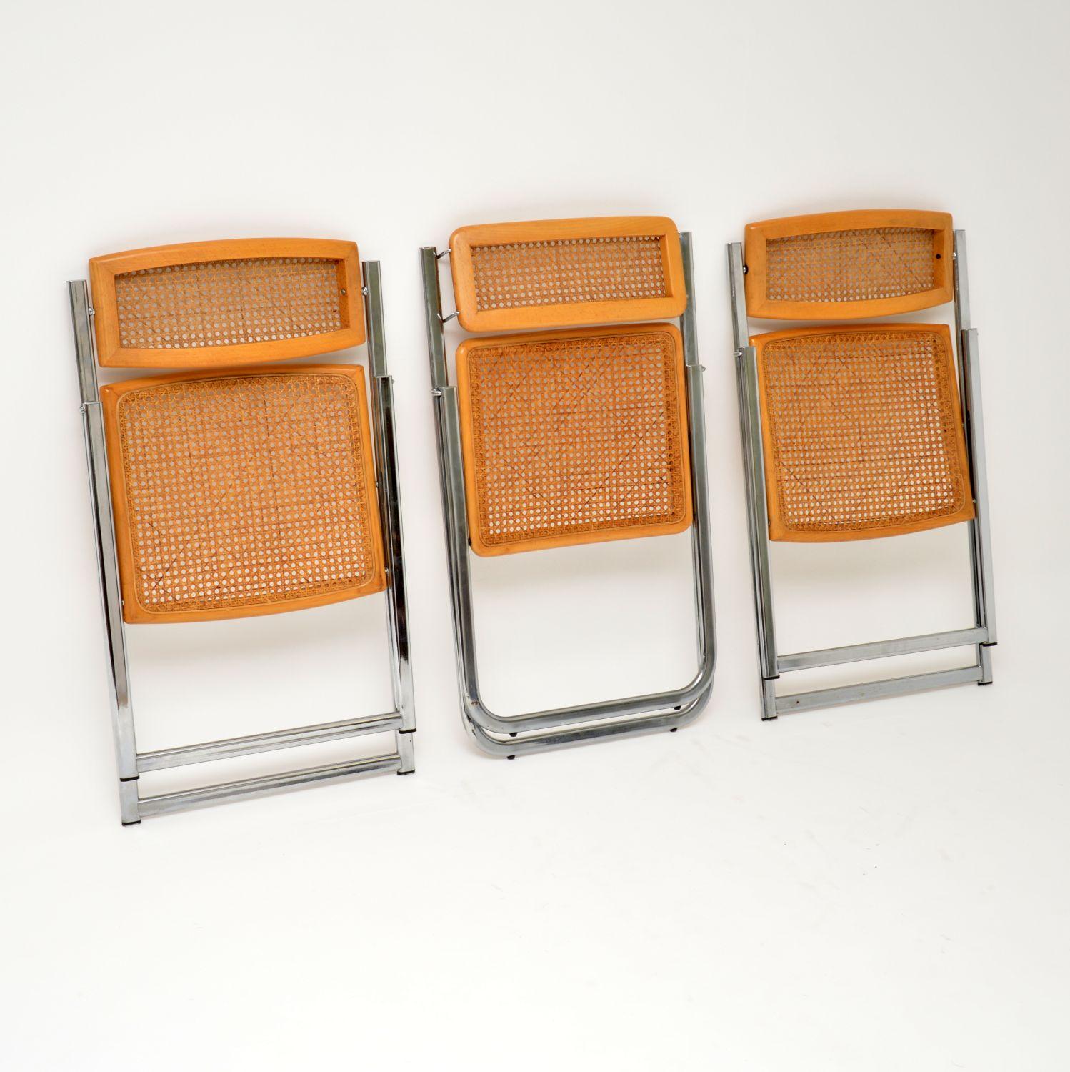 A beautifully designed set of three vintage folding chairs, these were made in Italy by Arben in the 1970-1980s. The quality is excellent and they are in superb condition, with barely any wear to be seen; the cane has no damage anywhere. Two of the