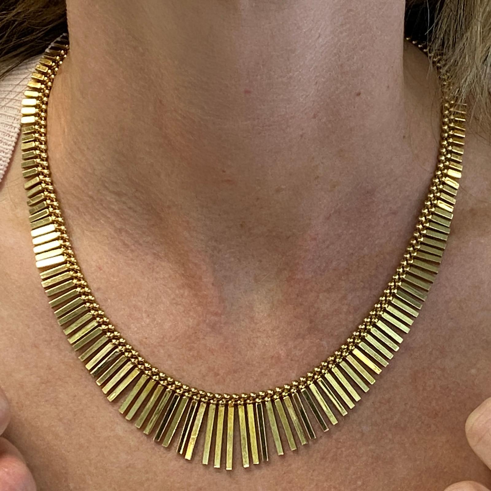Vintage Cleopatra necklace fashioned in 14 karat yellow gold. The beautifully kept high polish necklace features drops measuring .25- 1.00 inches, the necklace measures 16.5 inches in length. 