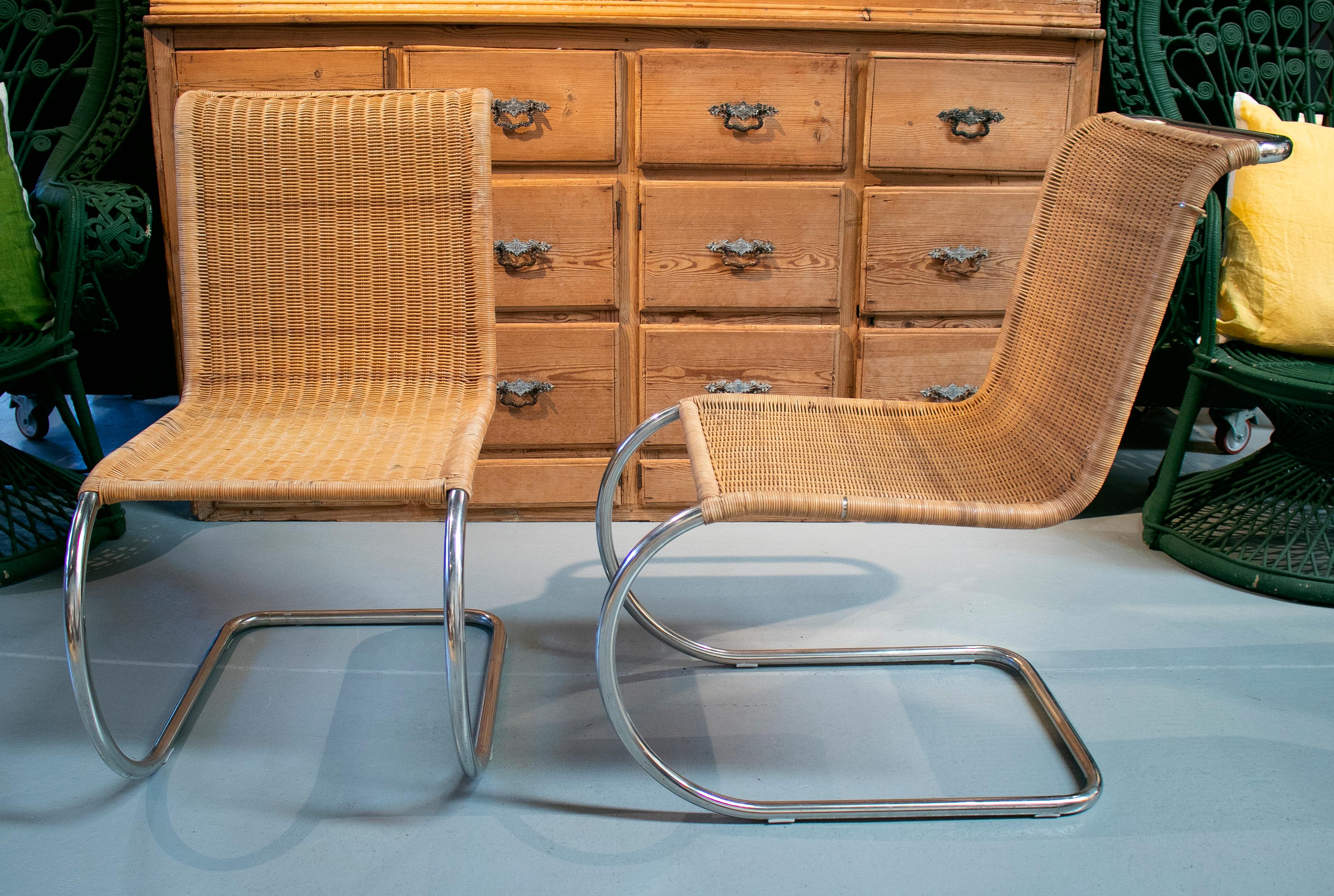 1970s Italian designer chairs with steel structure and weaved rattan.