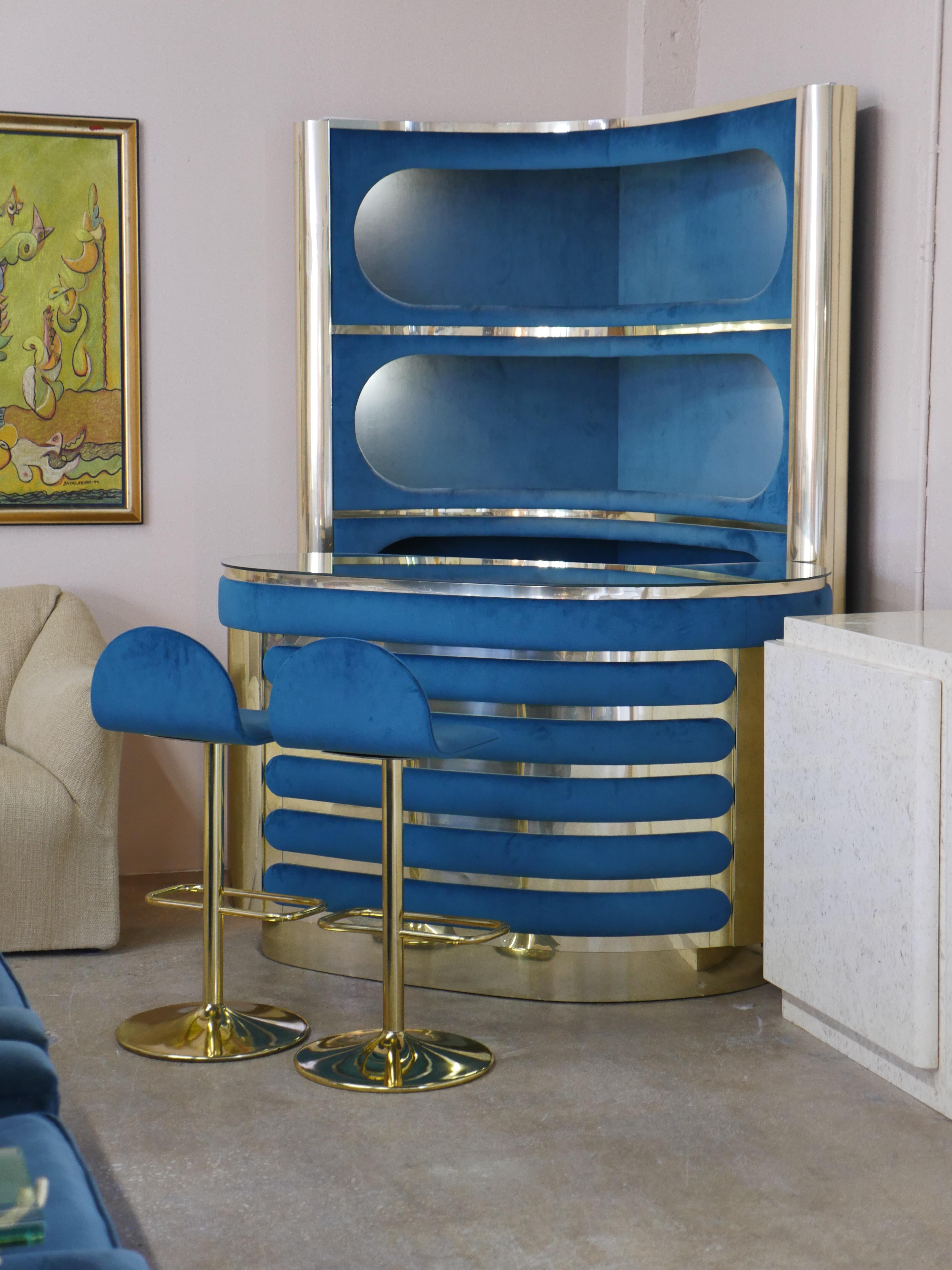 Iconic 1970s Italian bar set attributed to Willy Rizzo is a true statement piece that instantly transports you to the glamorous lifestyle of the era. Featuring rich emerald velvet suede upholstery, elegant gold detailing, and a sleek mirrored glass