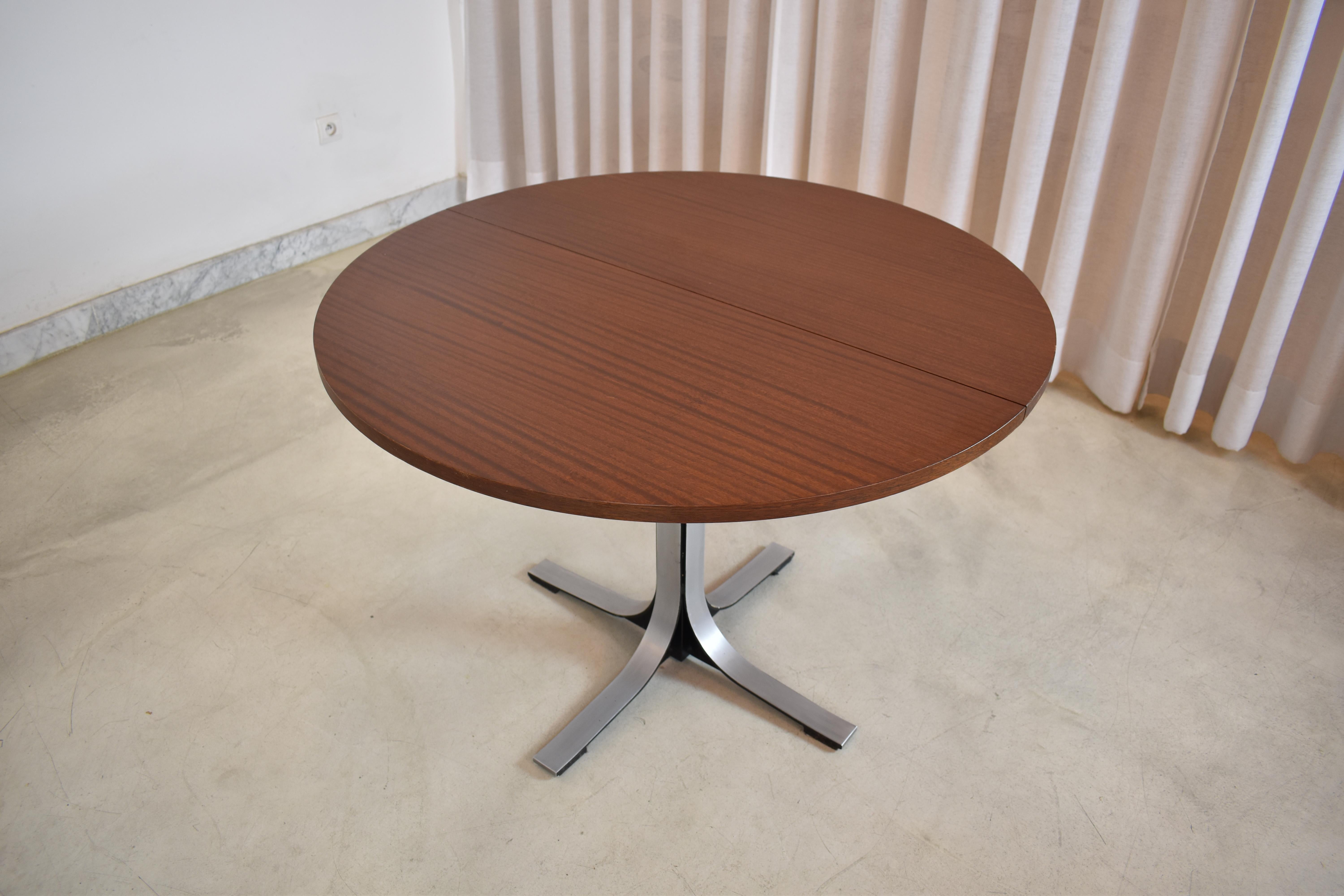 The Osvaldo Borsani by Tecno transformable walnut table manufactured in the 1960s, embodies his signature blend of sleek design and functionality by transitioning from a low coffee table to a high dining table. 

Its Scandinavian-inspired aesthetic
