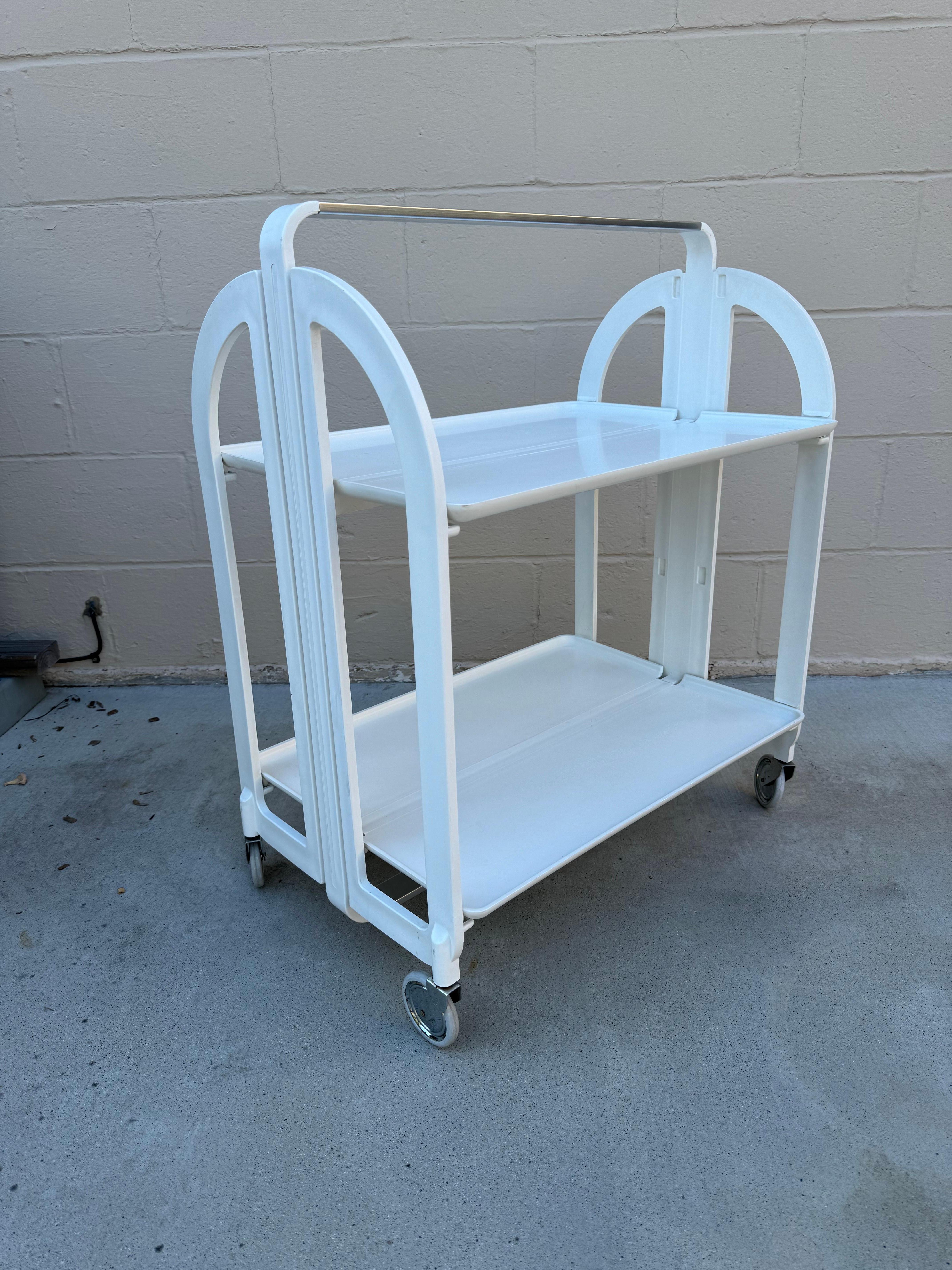Elevate Your Space: Fratelli Guzzini Italian White Plastic Bar Cart

Are you searching for that perfect blend of functionality and style to enhance your living space? Look no further than our exquisite offering: a beautiful white, plastic bar cart
