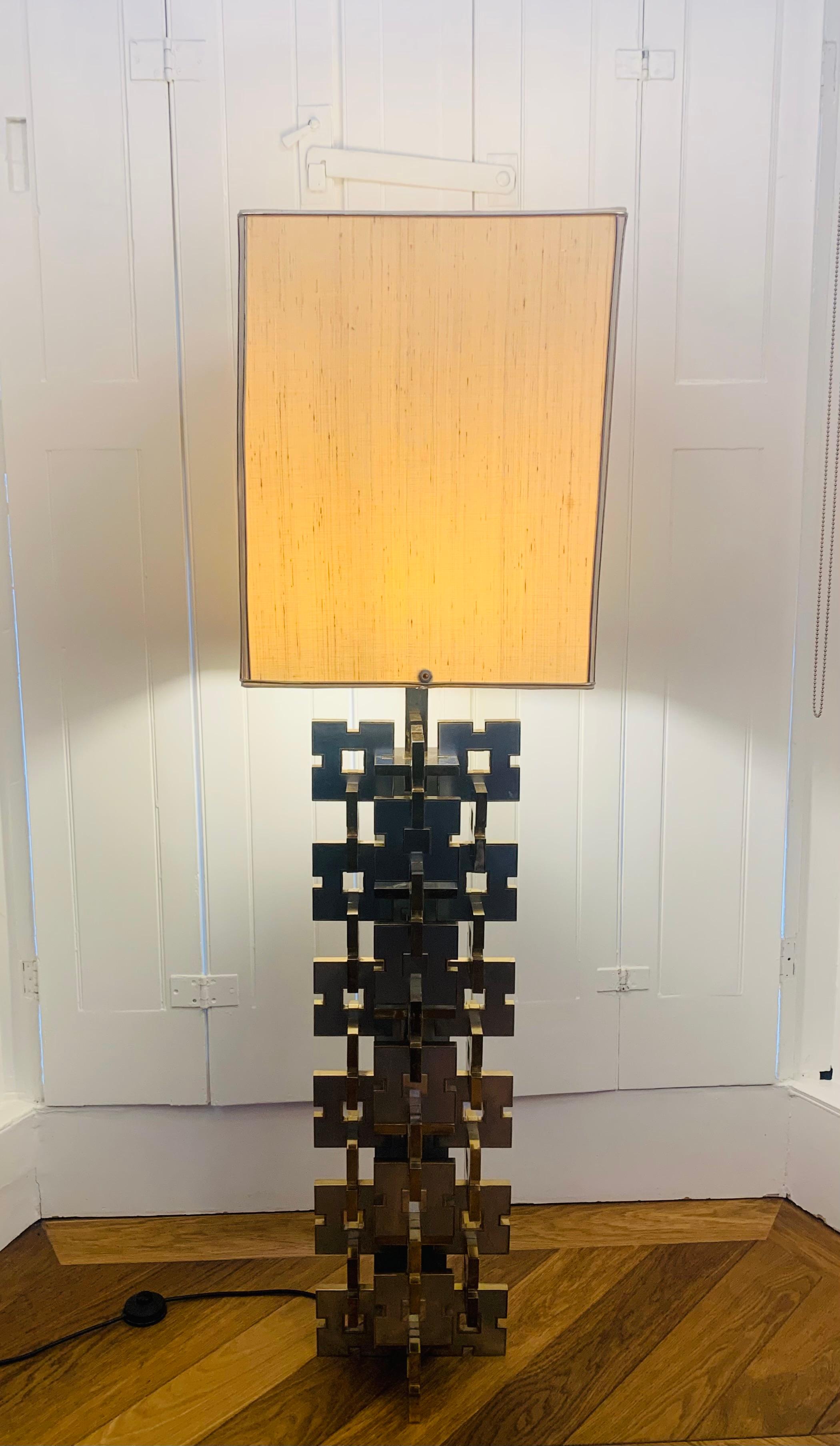 A rare, striking and beautifully designed Italian floor lamp constructed from alternate, interlocking, identical, silver squares with brass edges. This beautiful lamp was designed by Gaetano Sciolari for Sciolari Lighting during the 1970s. The