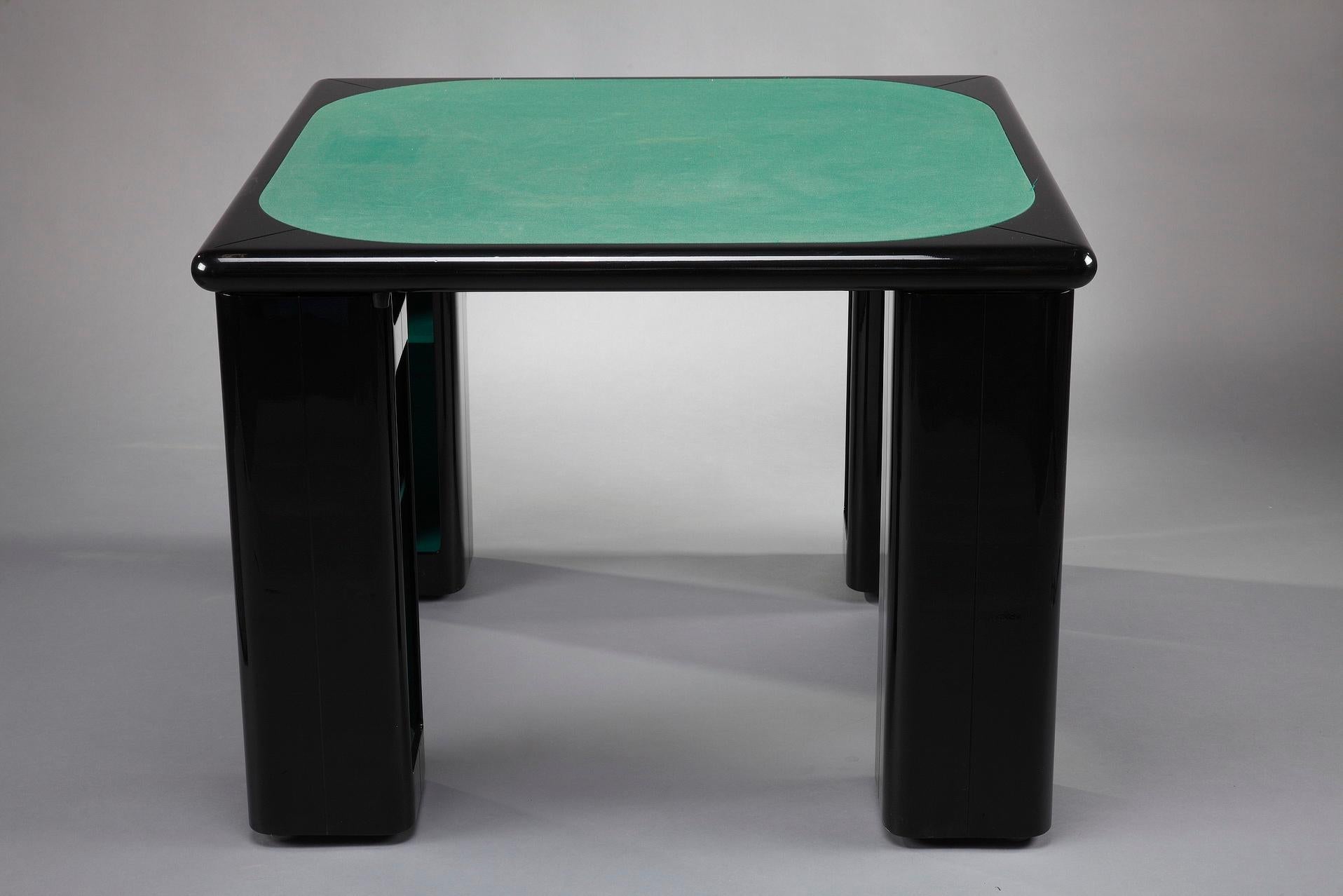 Italian game table for bridge, cards and poker by Pierluigi Molinari (Milan, 1938) for Pozzi Milano. Structure in lacquered ebony wood. The four cubic legs can rotate around a chrome tube to reveal storage compartments for games, cards or bottles.