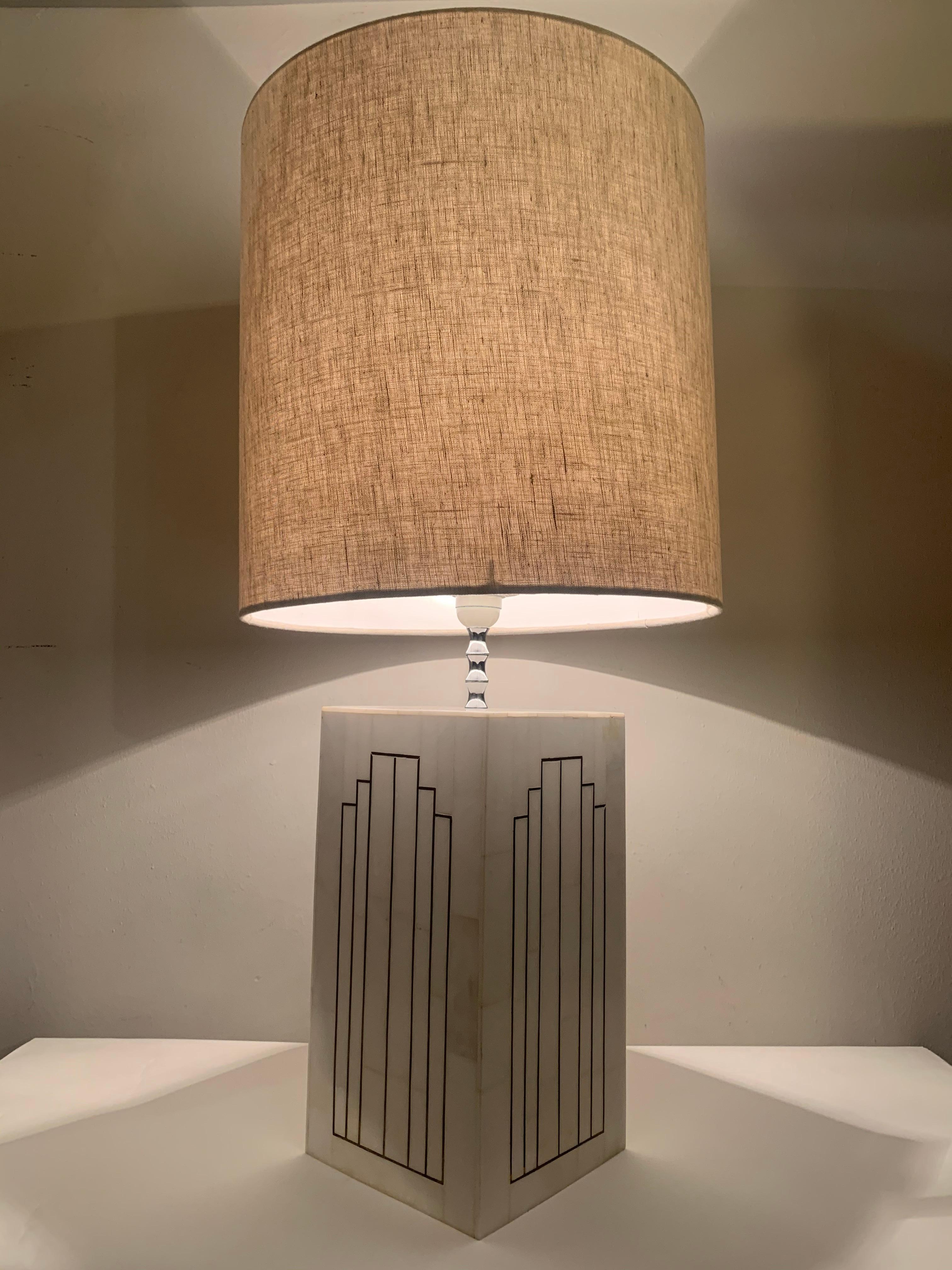 1970s Italian inlaid marble table lamp with an interesting copper geometric Art Deco style inlay. The mosaic marble is laid onto a heavy wooden base with a polished chrome stem and the original plastic bulb fitting. The original wire drum shade has