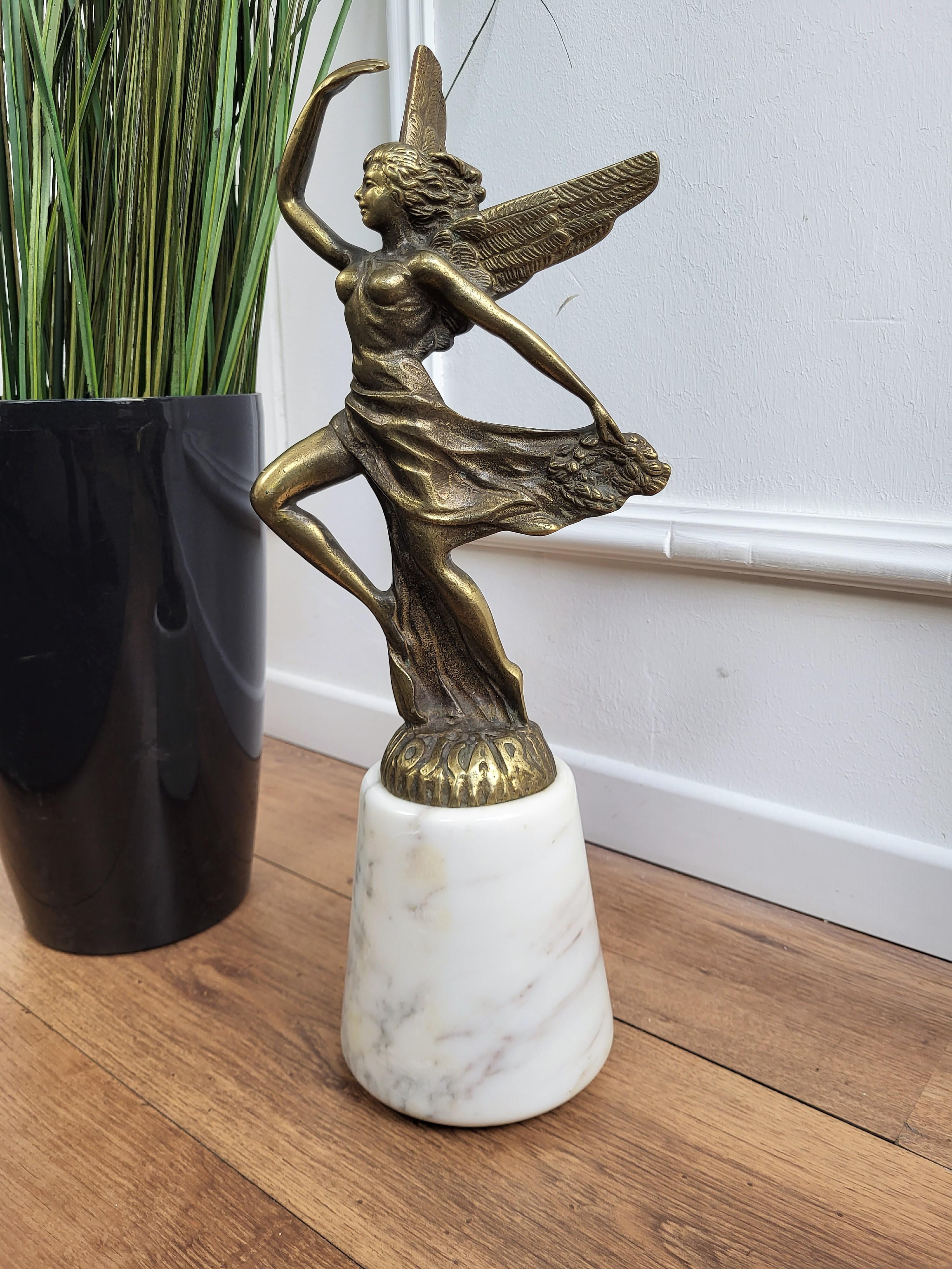 Vintage 1970s Italian stylish brass and marble doorstop, with great design representing a sculpture statue female figure with angel wings, realistically cast and modeled. Originally intended as an academy award, as written the bottom, it is ideal to