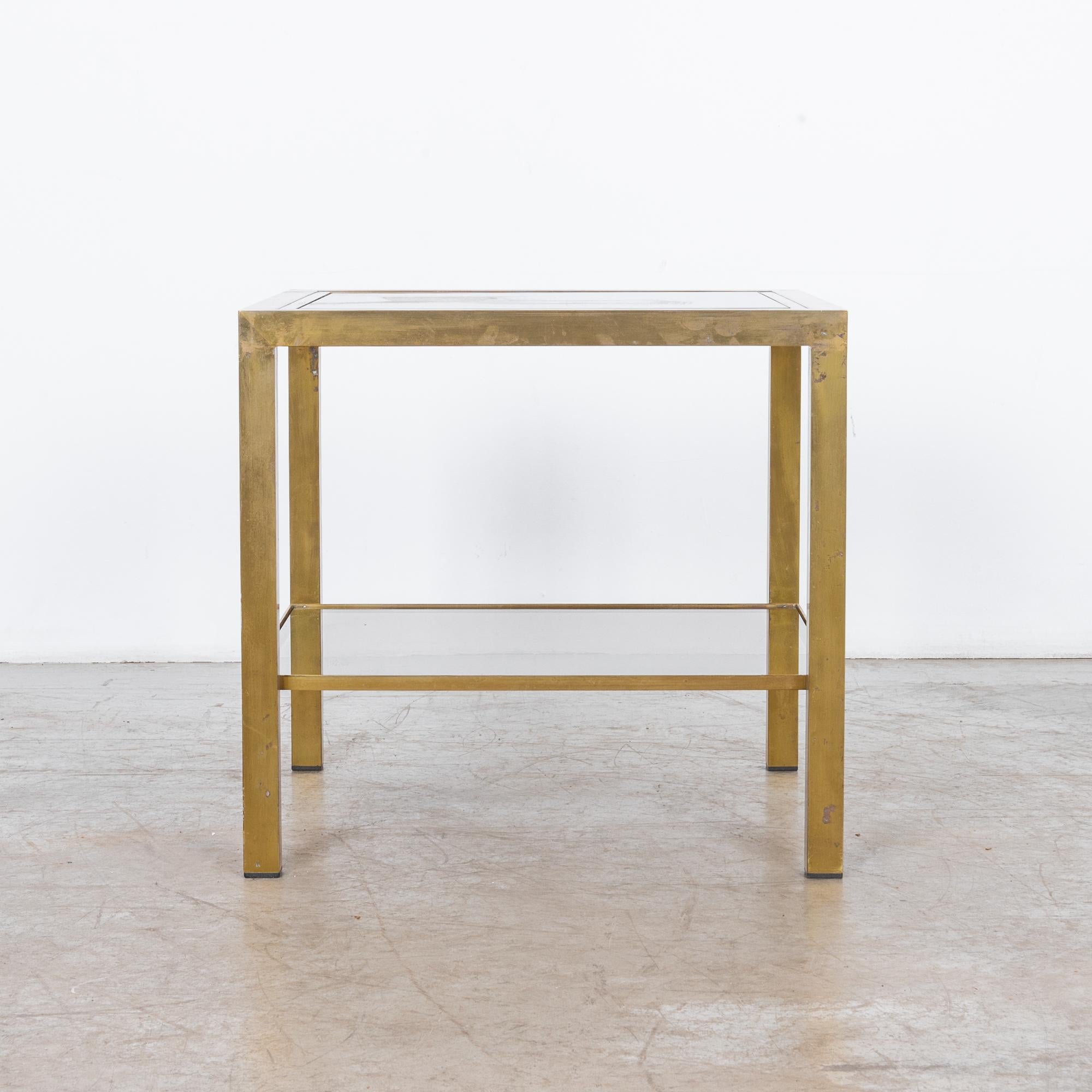 Stylish coffee table with glass top and brass-plated legs. Metal and glass, a timeless combination. The optical properties recall cathedrals and palaces, an association with light. Adopted and expanded in the industrial age with straight edges and