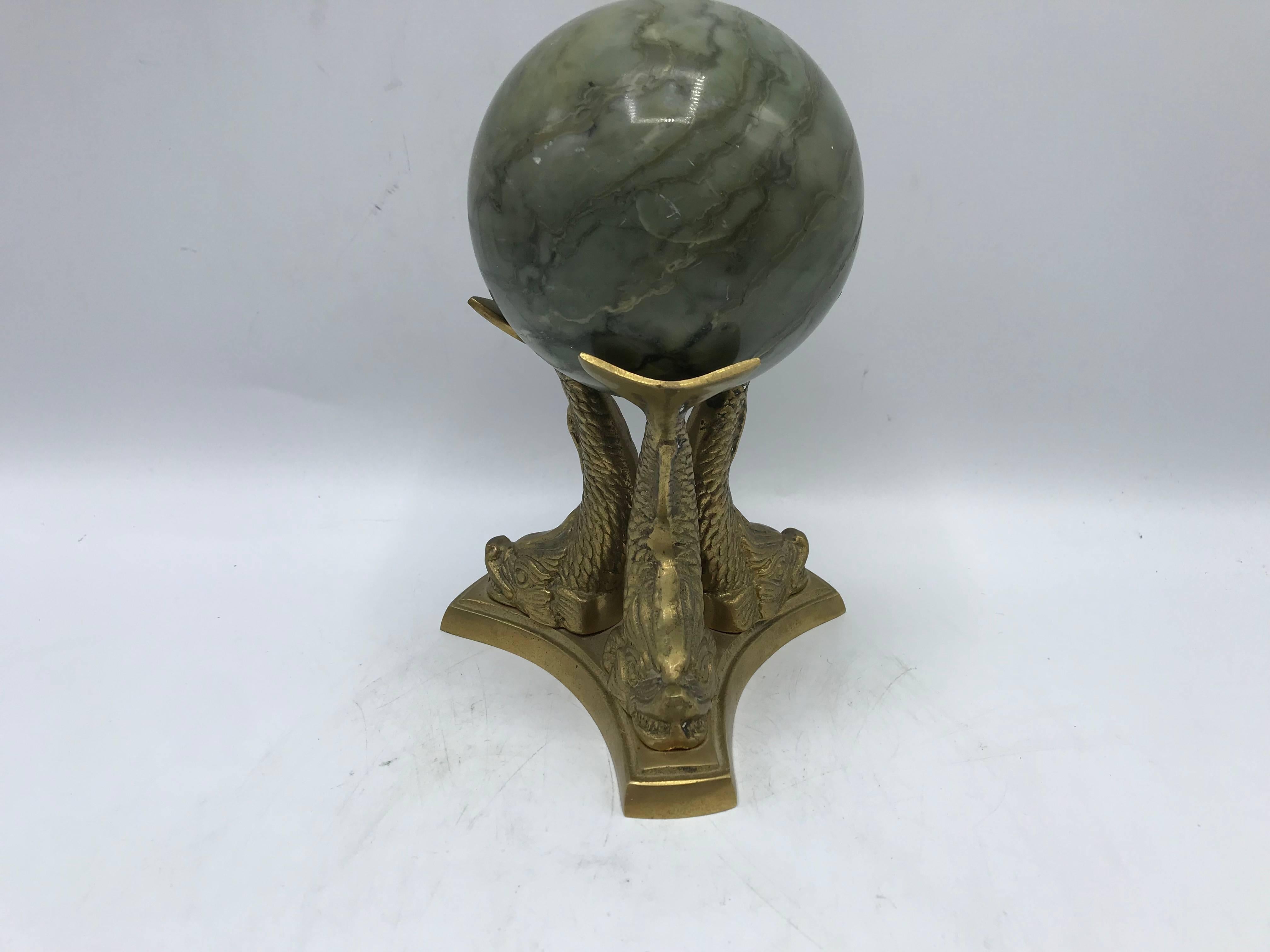 Offered is a beautiful, 1970s Italian green solid-marble ball sculpture. The piece is rested on a brass koi fish sculptural base. Heavy, weighing just under 5 pounds.