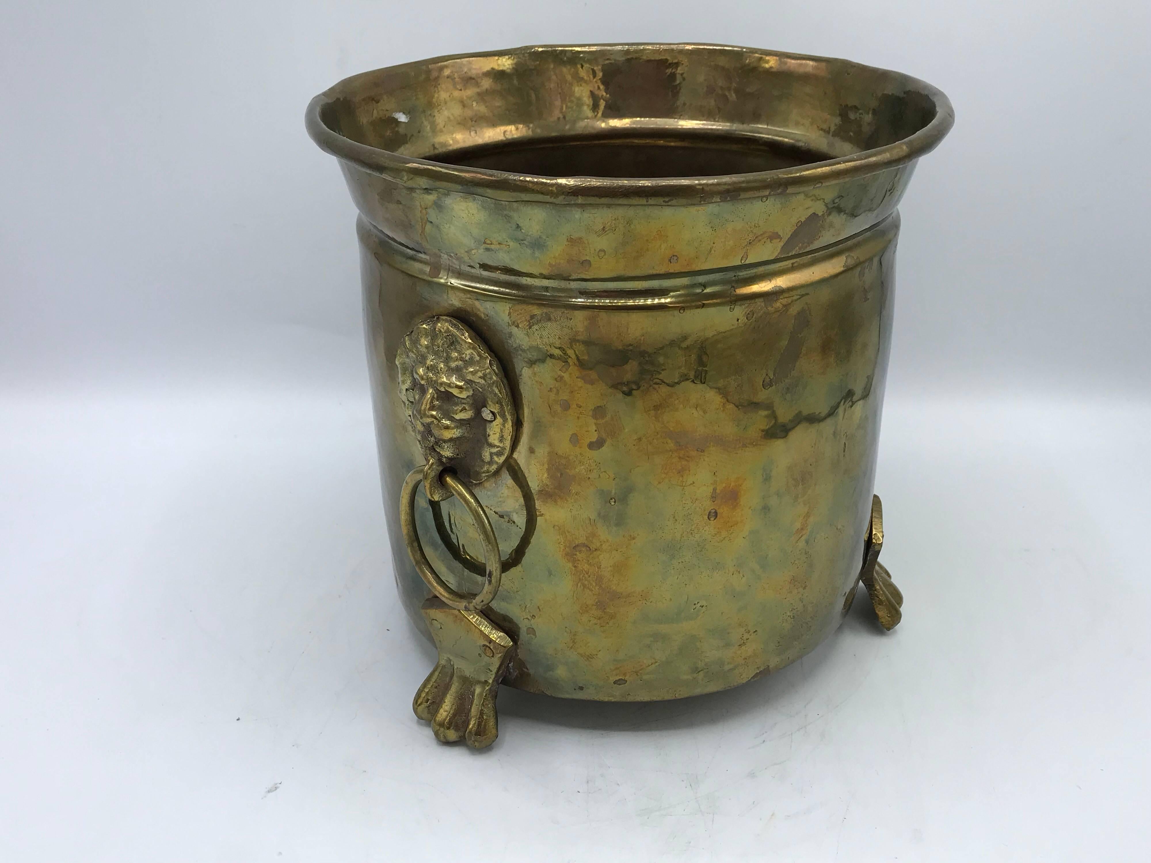 Offered is a beautiful and traditional, 1970s Italian hammered-brass cachepot planter with a lion head pull and foot motif. Heavy.
