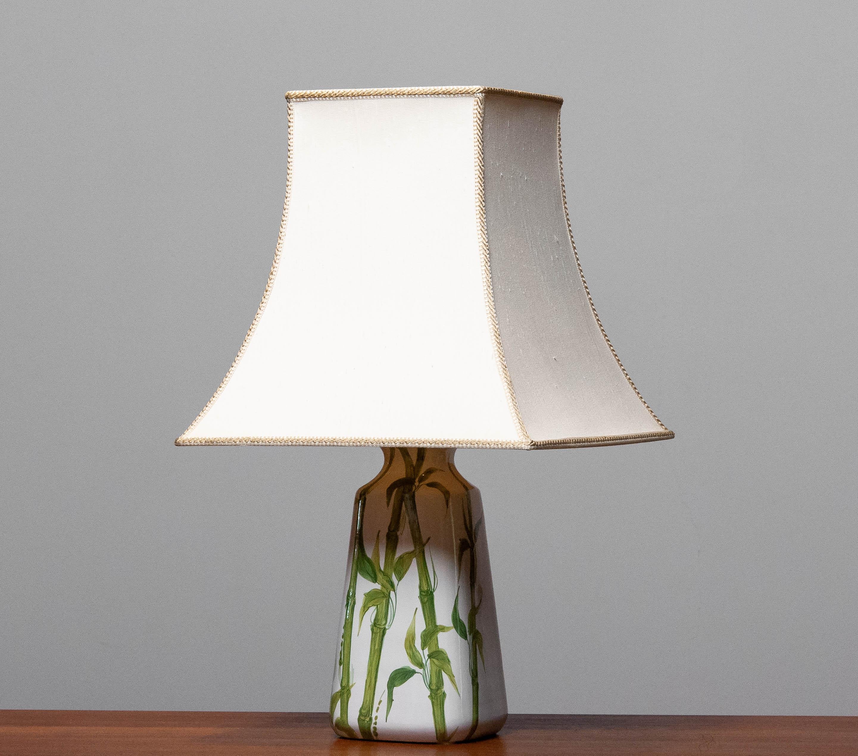 Beautiful 1970's white ceramic table lamps made in Italy and hand painted with bamboo decor. The lamp is in perfect condition. The lamp is numbered as style VII and labeled.
The screw fitting is from a later period. 
Allover this lamp is in very