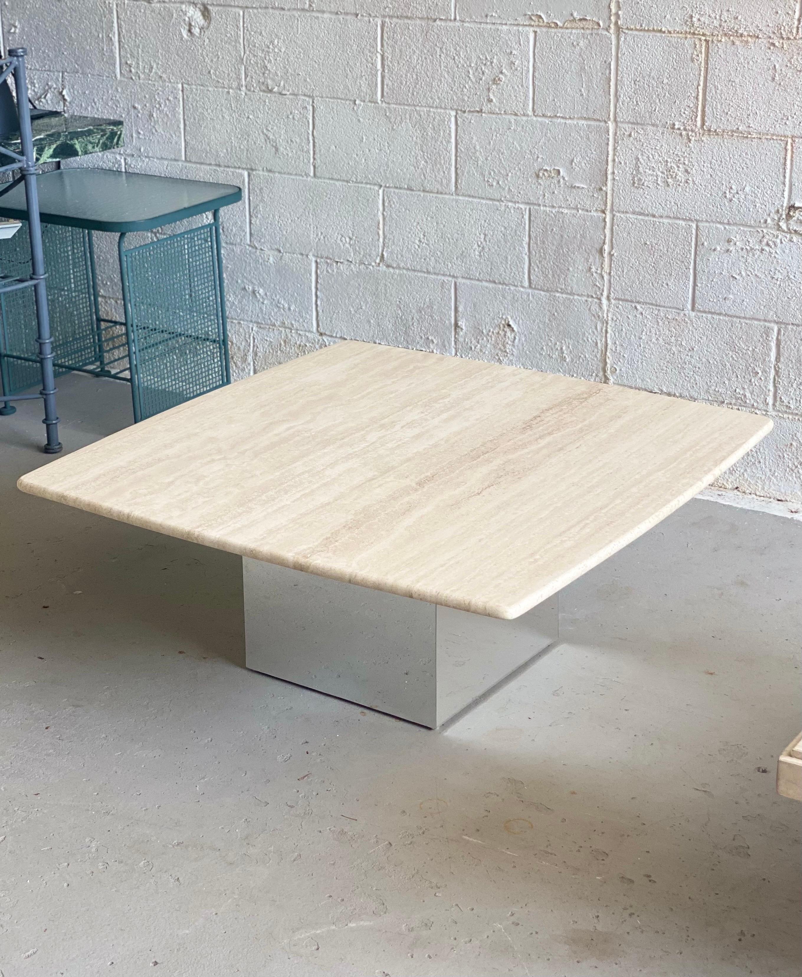 We are very pleased to offer a classic, chic coffee table, circa the 1970s. This coffee table is a beautiful balance of simple forms and finishes. A square base, with a metal chrome finish, makes a stable support for a heavy, square travertine stone