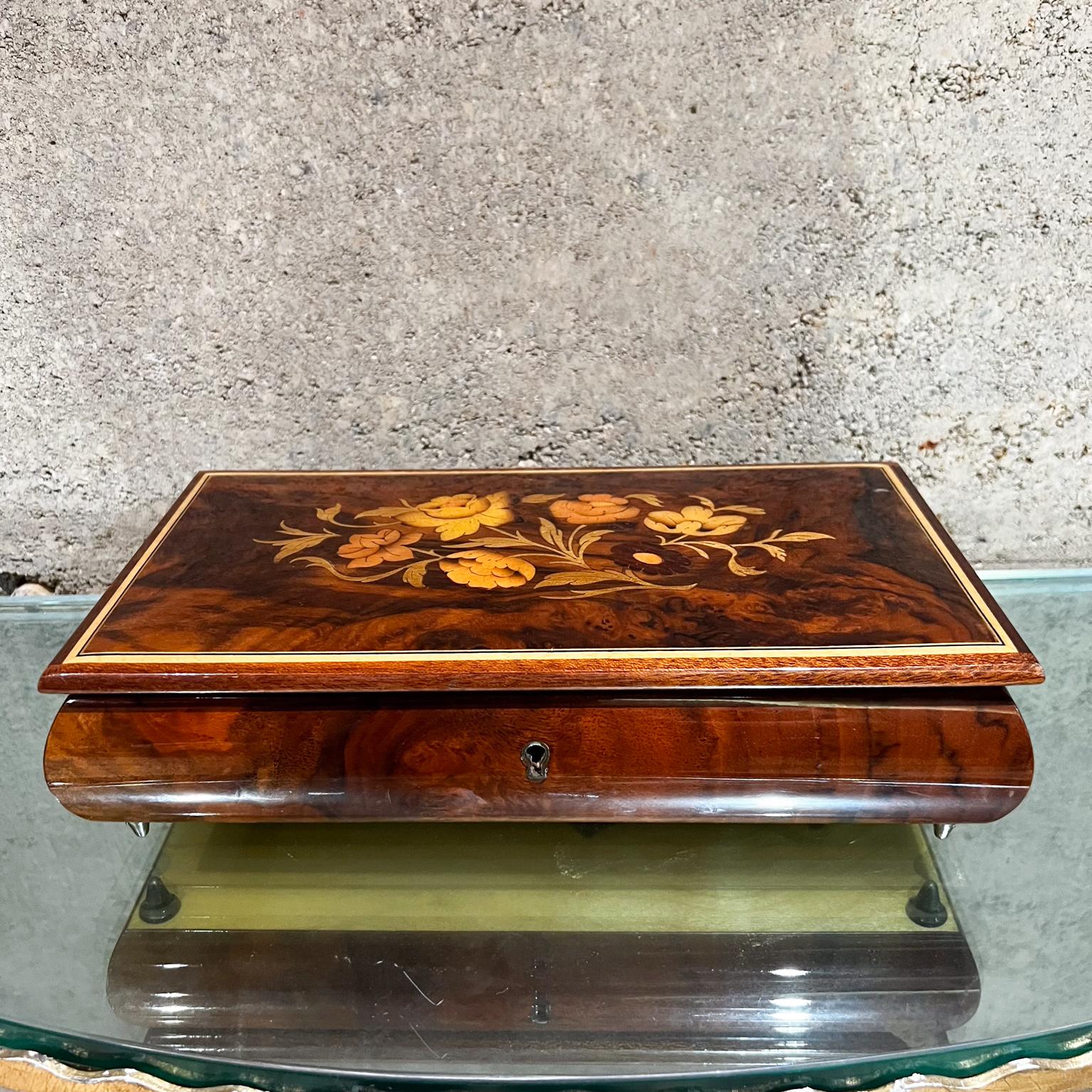 1970s Vintage Reuge Wood Music Box Italian inlaid marquetry jewelry box.
Elegant footed music box in and crafted fruitwood.
Glossy Enamel Finish.
Red velvet interior.
Reuge Ste Croix Demain Collection.
2.75 tall x 6 d x 10.75 w
New key to rewind and