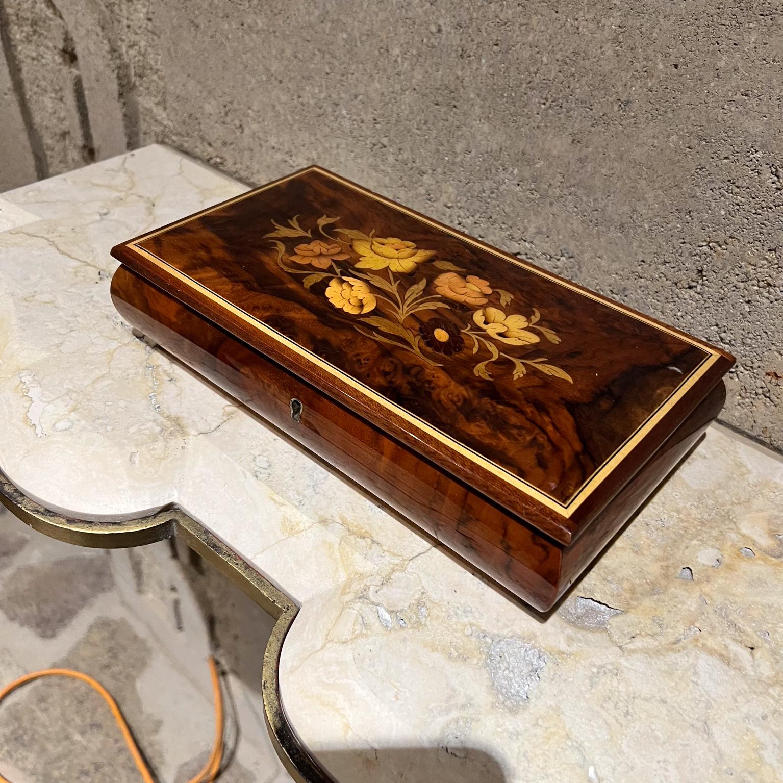 1970s Vintage Reuge Wood Music Box Italian inlaid marquetry jewelry box.
Elegant footed music box crafted fruitwood.
Glossy Enamel Finish.
Red velvet interior.
Reuge Ste Croix Demain Collection.
10.5 w x 5.75 d x 2.5 h
New key to rewind and play