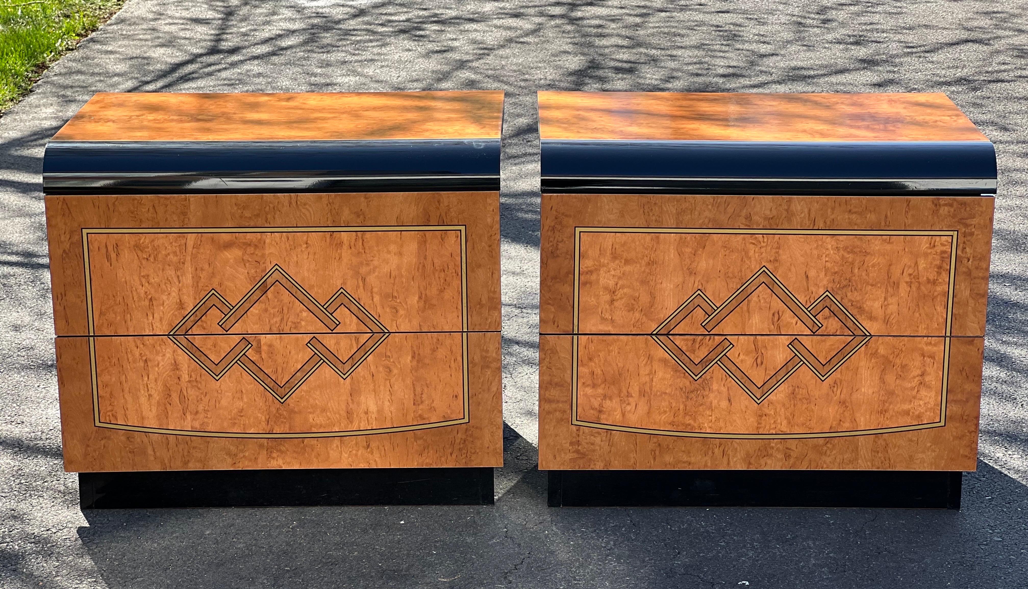 Elegant Italian nightstands with burl wood laminate. Finish is a high gloss with beautiful Hollywood Regency inspired pyramid motif design. The sides and plinth bases are ebonized laminate. Fronts are waterfall style. Clean pair with little use