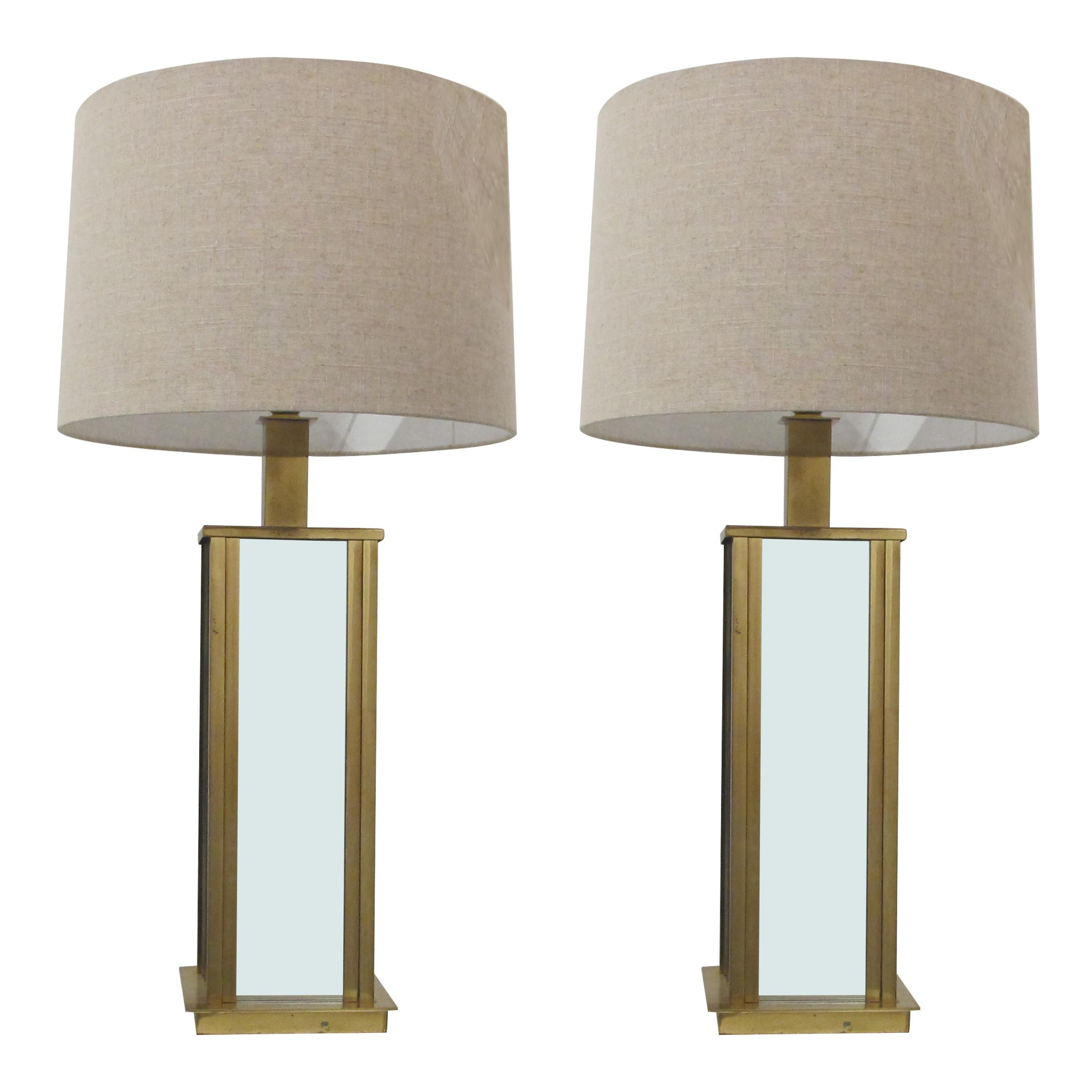 Elegant very well made Mid-century Italian large rectangular pair of table lamps with four mirrored facets encased in a brass frame. The frames have acquired a little bit of tarnishing which does not distract from the overall look of the lamps. One