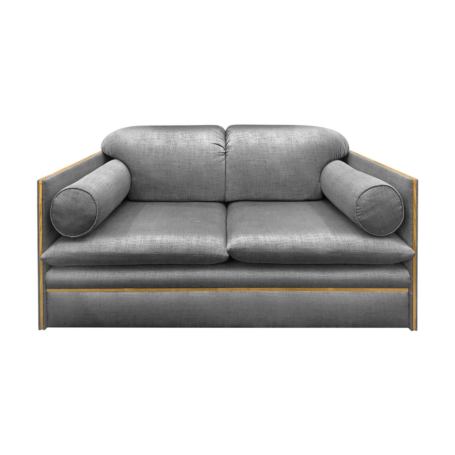 Loveseat with bolster cushions and brass profile newly upholstered in a charcoal sheen fabric. Signed illegibly on arm, Italy, 1970s.