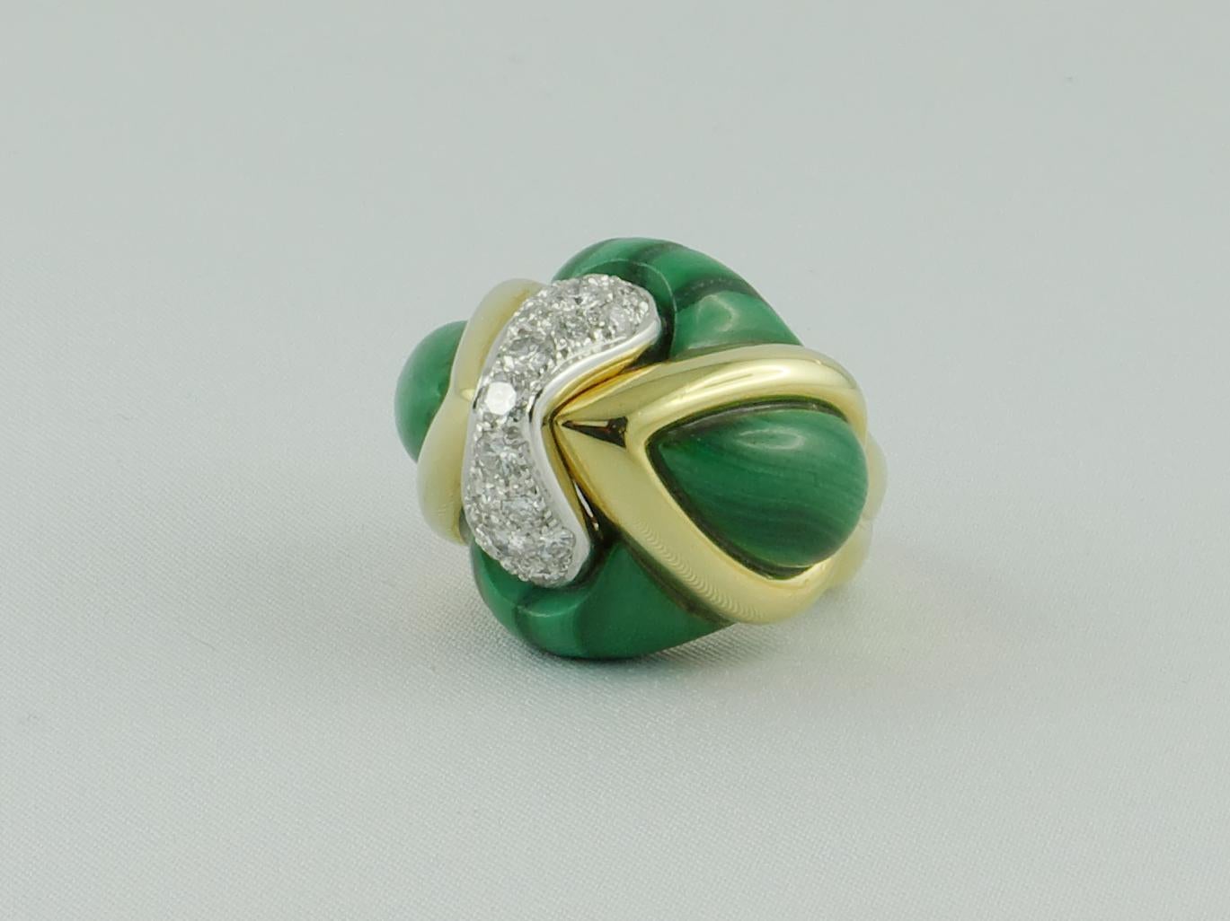 Unusual 1970s Italian Diamonds White and Yellow Gold dome Ring in Malachite shaping a textured pointed dome
The design is enhanced by a stroke of approx. 0.65 cts brilliant diamonds running through the center and set in 18 karat White Gold while the