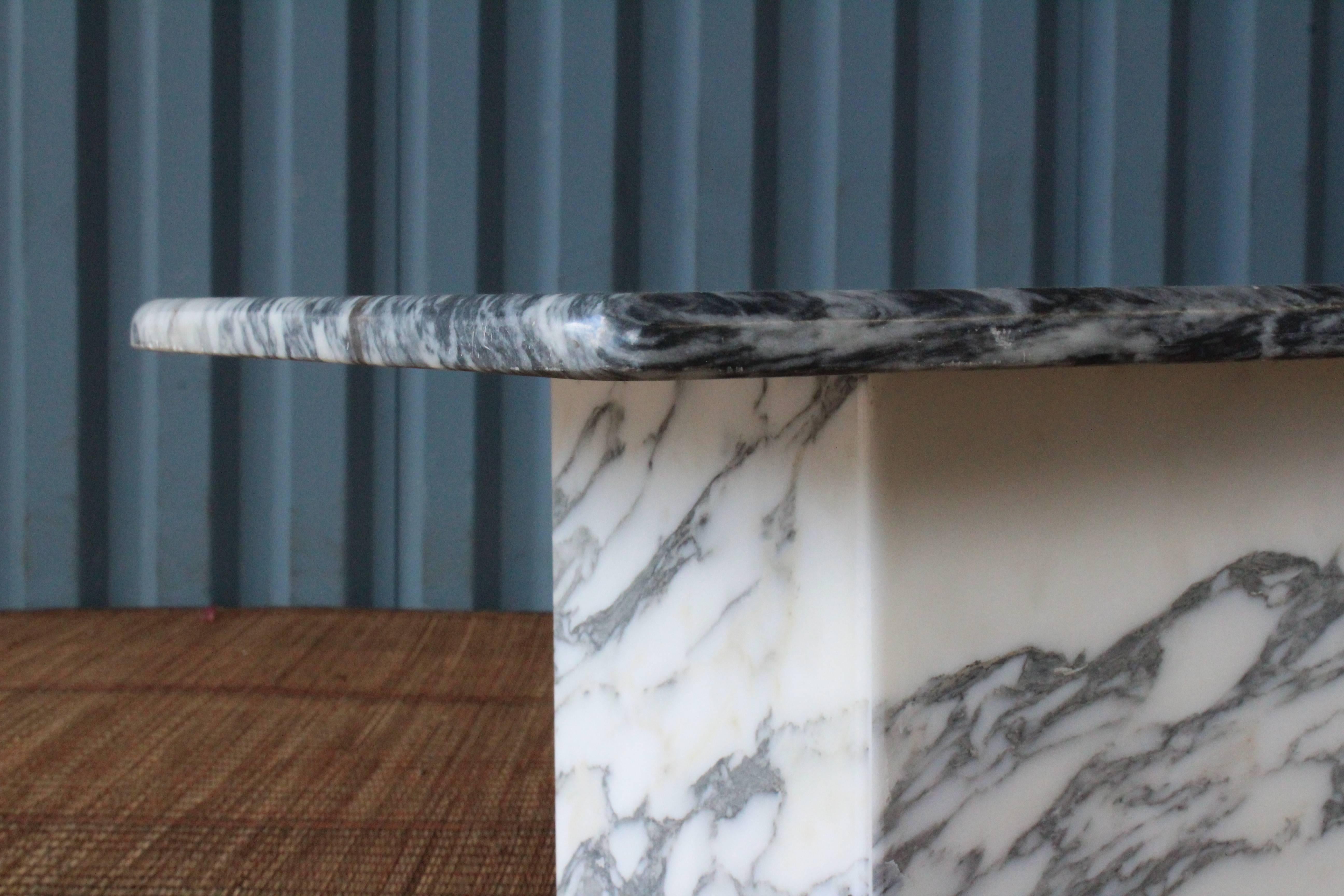 Stunning 1970s Italian marble coffee table with interesting curved corners. Top sits on top of two corner bases. 