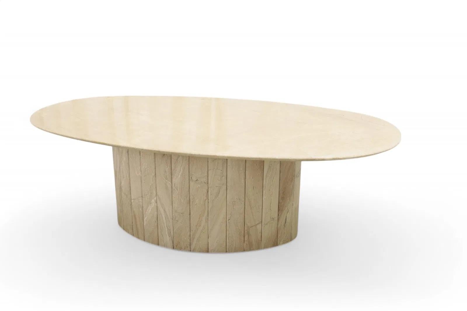 An elegant Italian marble coffee table featuring a richly veined oval marble top set above a sculptural faceted base.


