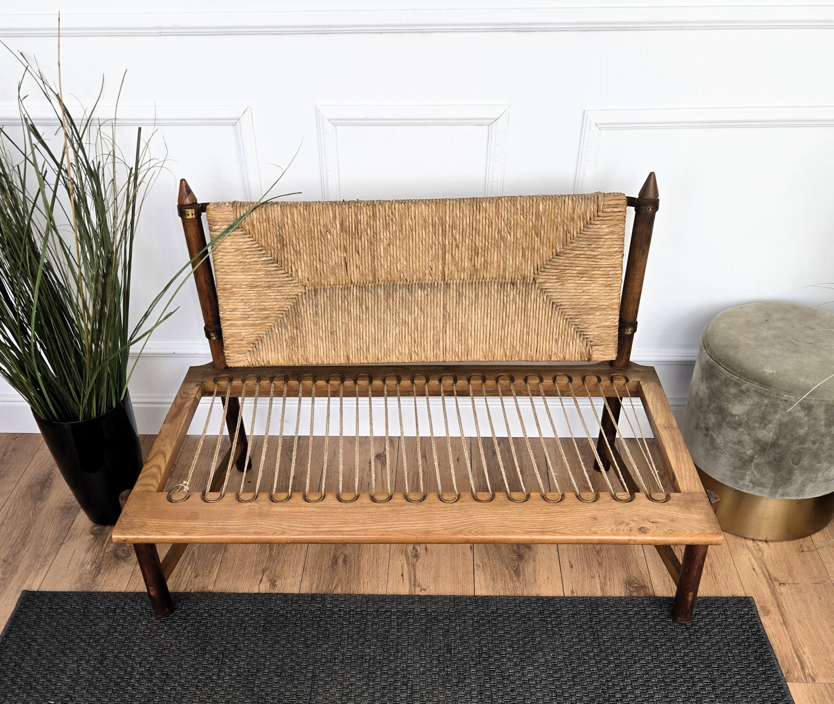 Stylish and beautiful 1960s Mid-Century Modern bench lounge sofa in wood with new seating pillow and cord or woven rope backseat completed with brass details. The traditional and classical design and shape of the wooden structure perfectly