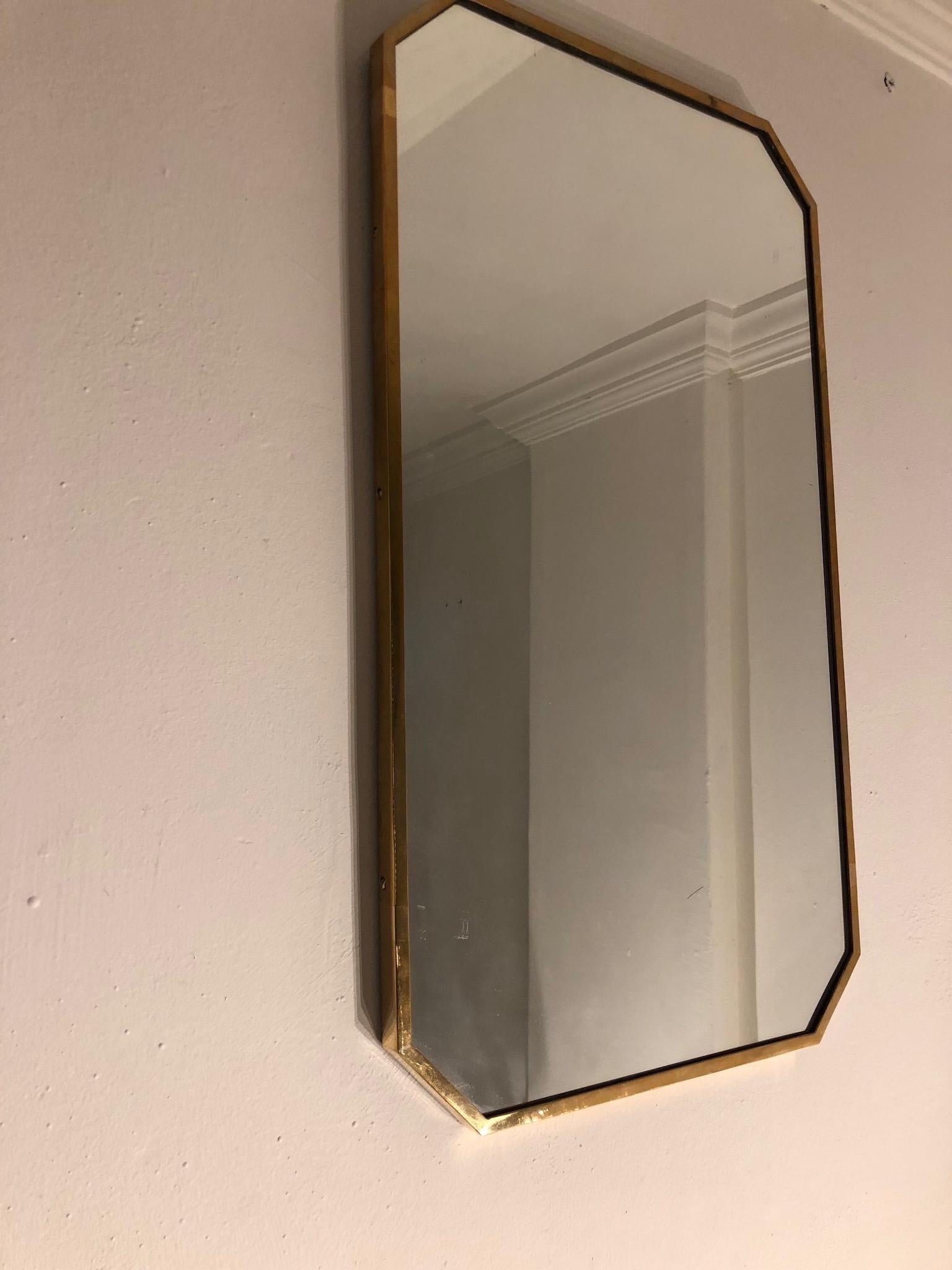 Italian 1970s mirror with cut corners brass frame.