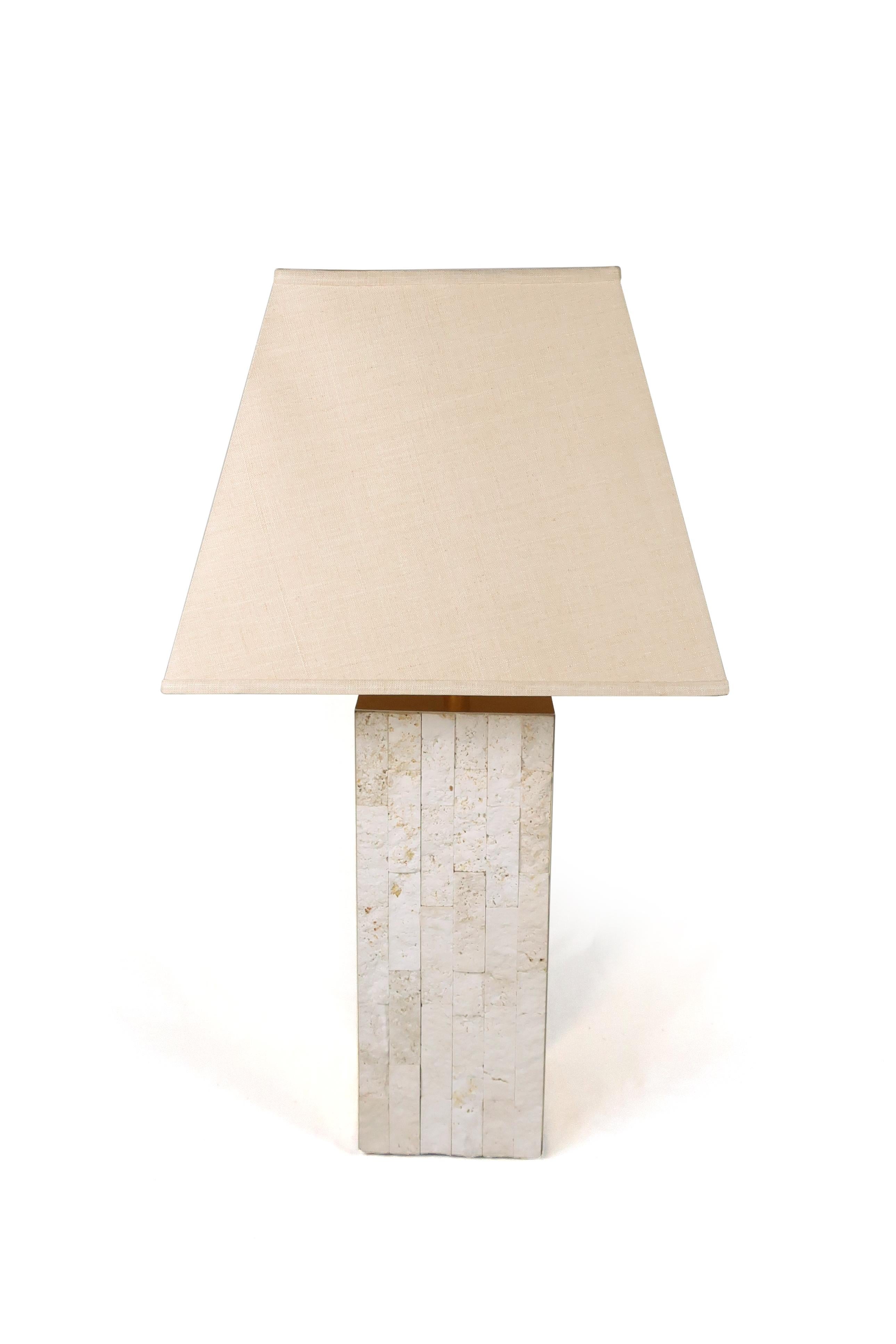 A stunning brass and travertine table lamp. Square base with two sides of stacked pieces of travertine and two sides of brass. A small dent in the top of the brass that can’t be seen when the shade is on. Unmarked and in excellent vintage condition