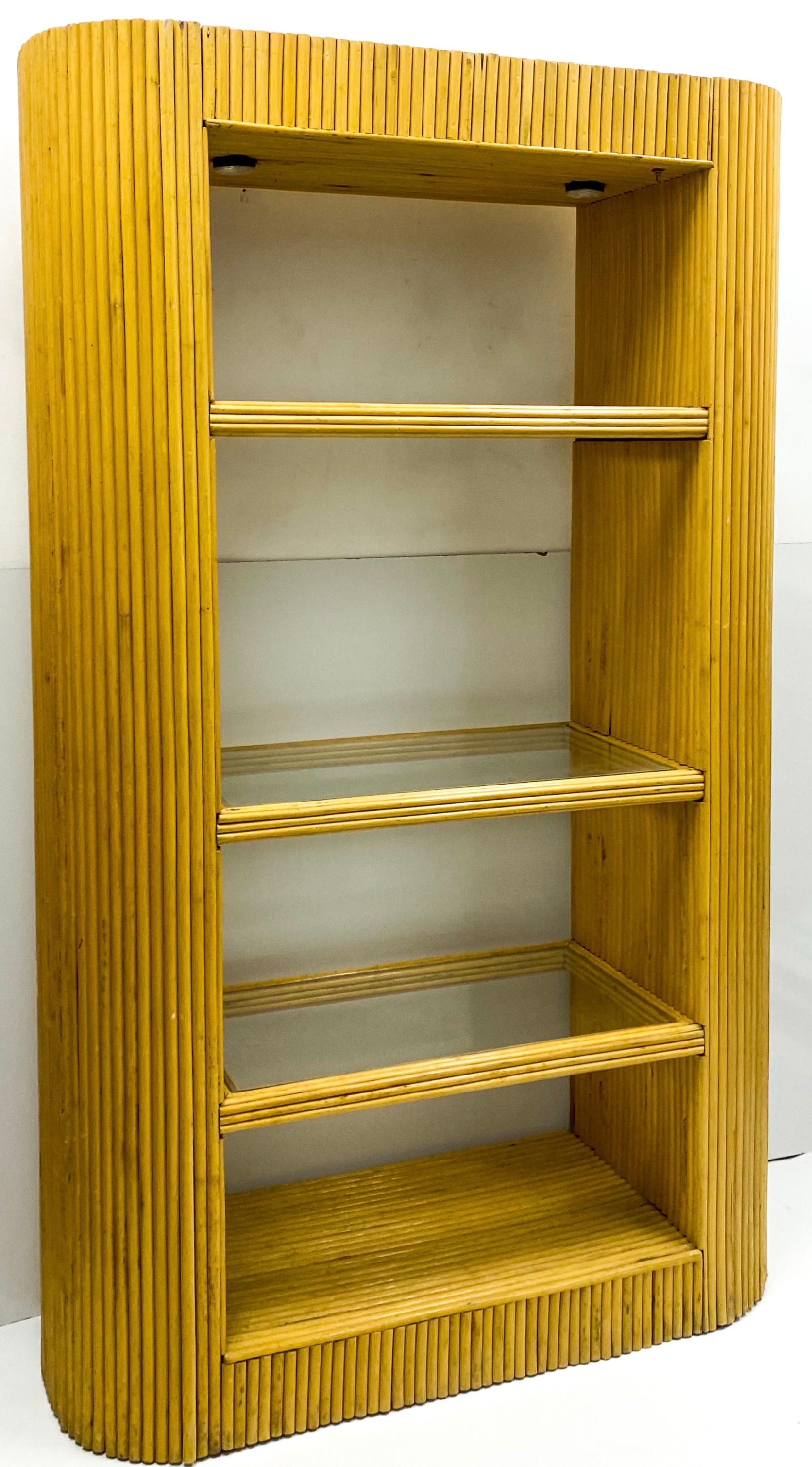 This is a 1970s Italian pencil bamboo etagere. It was finished by George Pazzano, but the maker’s mark is somewhat illegible. The shelves are glass. It is illuminated. From the floor upward is: 6”, 20”, 36”, 58.25”.