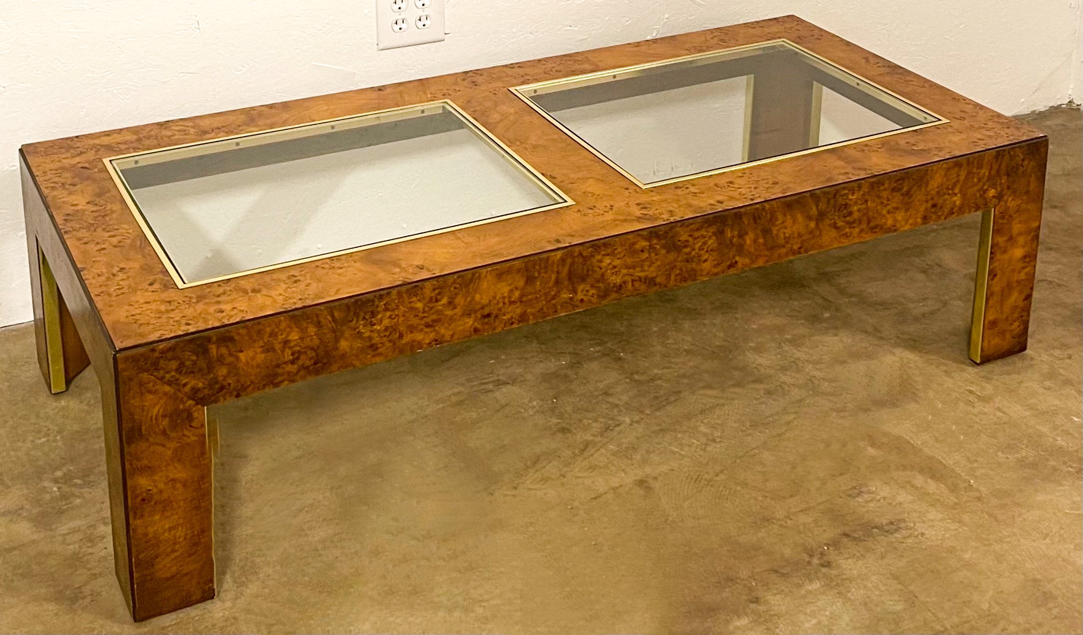 This is wonderful! It is an Italian burl, brass and glass coffee table. The table is in the manner of Milo Baughman. It is in very good condition.