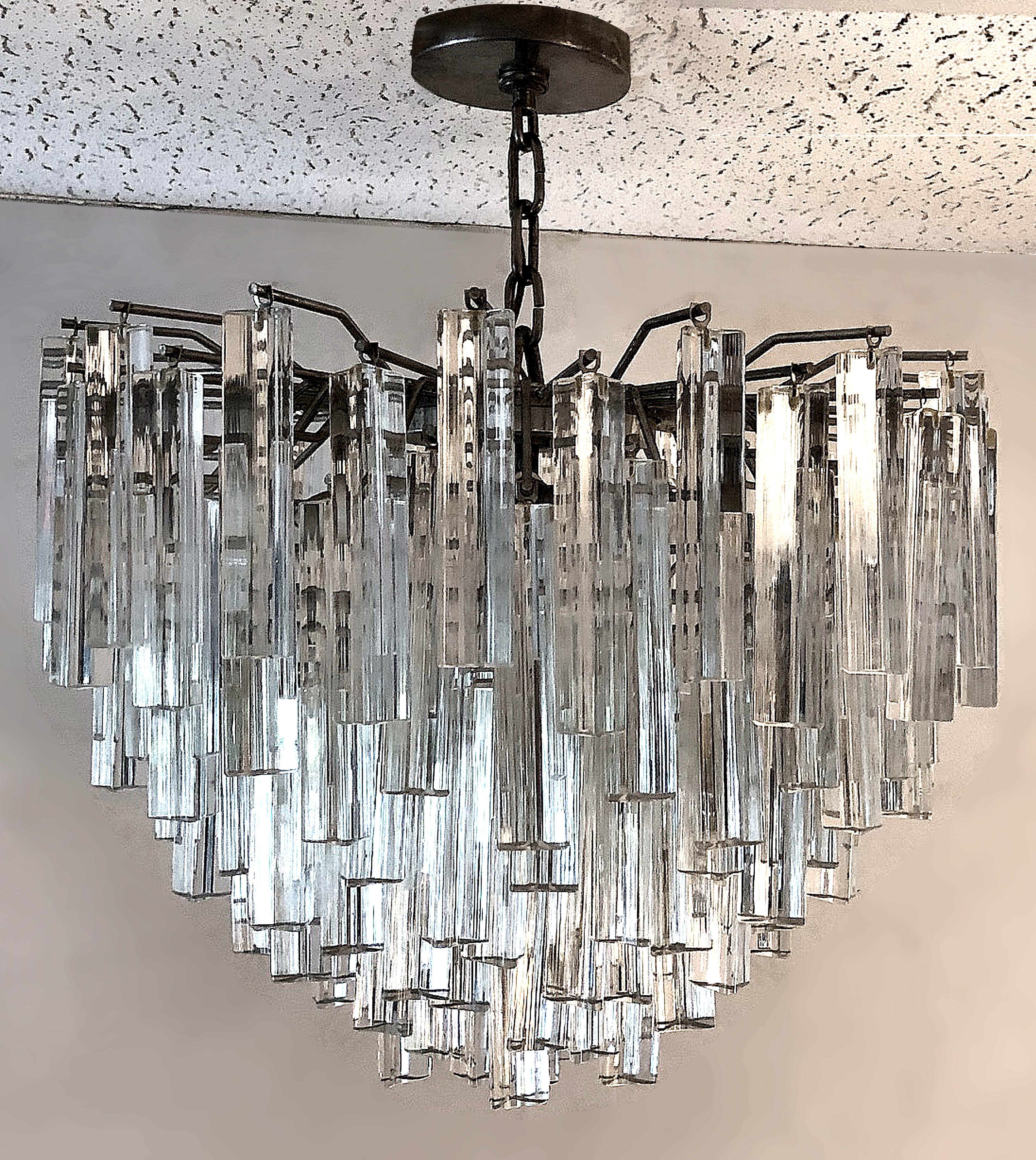1970s Italian Modern Venini Triedri glass chandelier

Offered for sale is a circa 1970s Italian Modern dense tiered chandelier with Venini Triedri glass spears. We have seven extra spears that will be included with the purchase. This round fixture