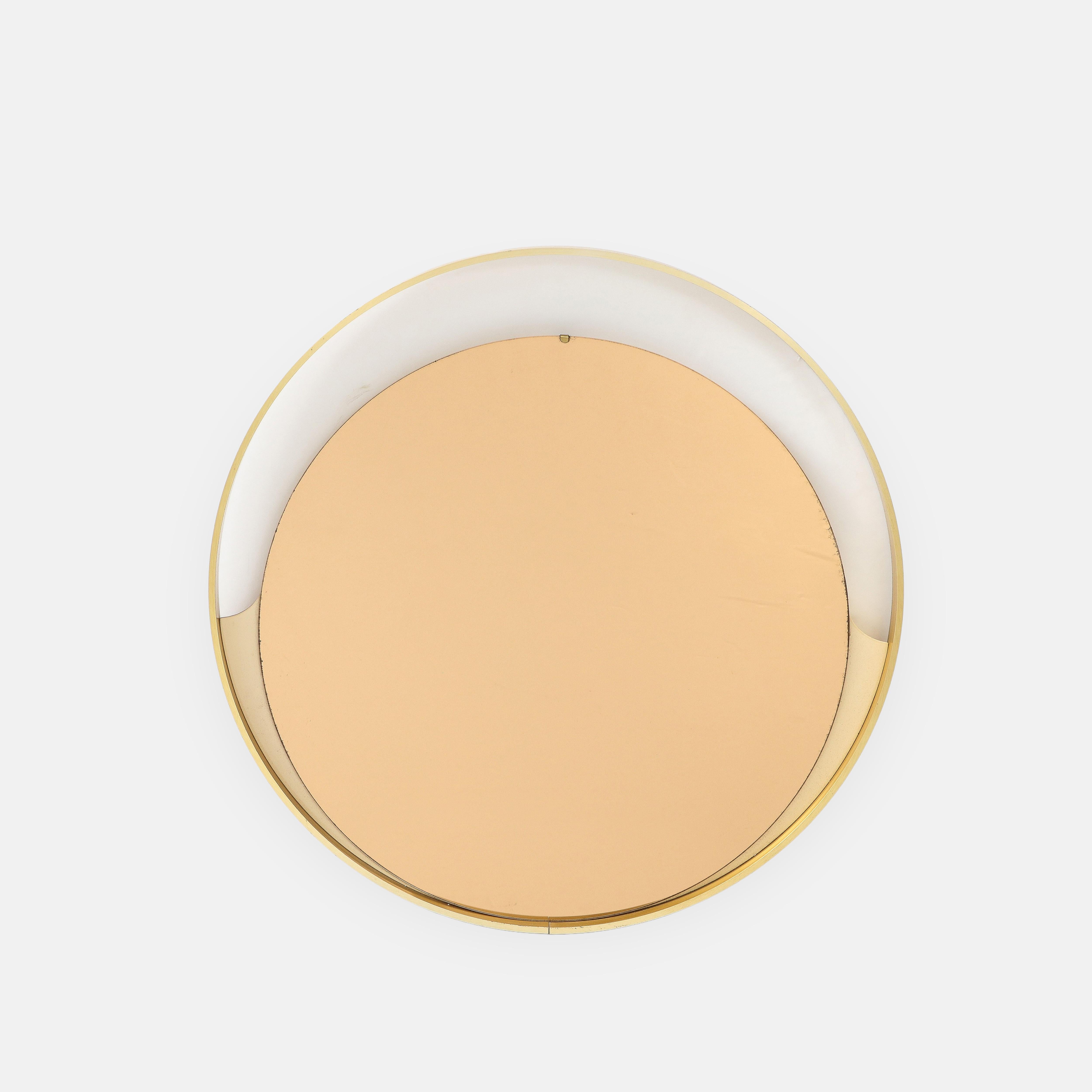 1970s Italian modernist round wall mirror with brushed gold or satin brass circular frame and smaller circular rose gold mirror mounted on lower half by lacquered ivory painted wood.  This stylish and chic mirror has lovely contrasting details