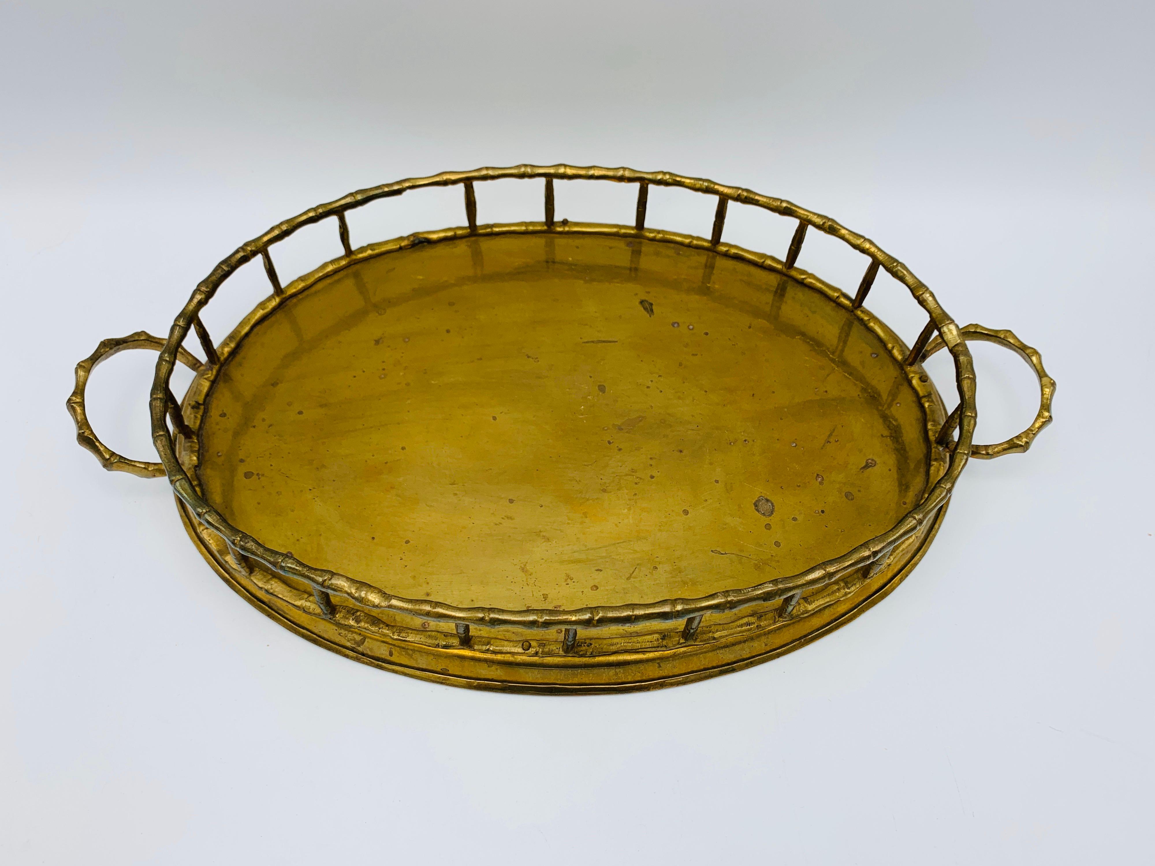 Listed is a beautiful, 1970s Italian Mottahedeh brass faux-bamboo oval tray. Lovely, all-over patina. Fairly heavy, weighing 1.8 lbs.