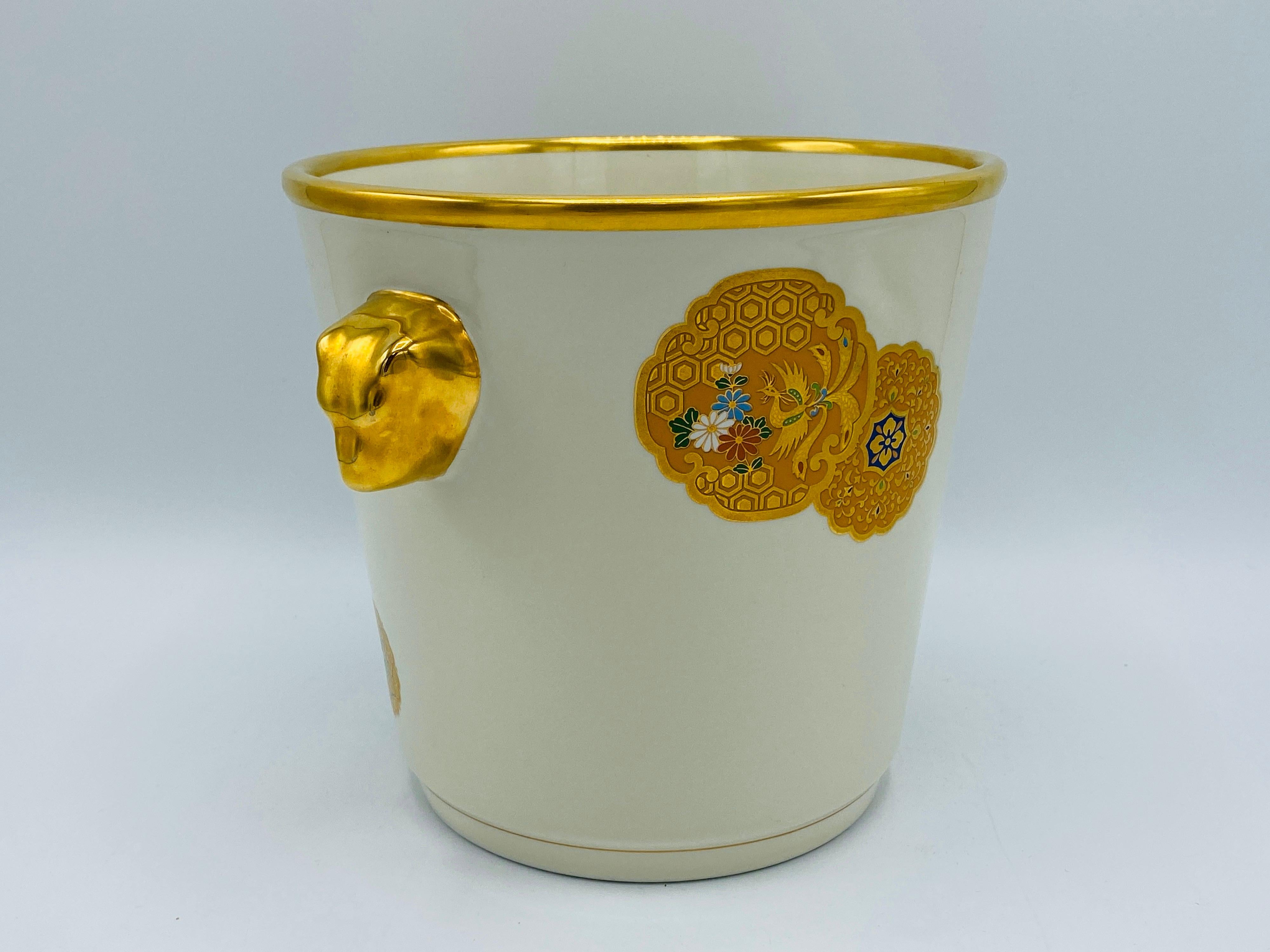 Listed is a fabulous and incredibly rare, 1970s Italian Mottahedeh champagne bucket. The piece is an ivory/white all-over with gold accents and three modern, Chinese medallions on each 'main' side and lions head handles. This would be a perfect