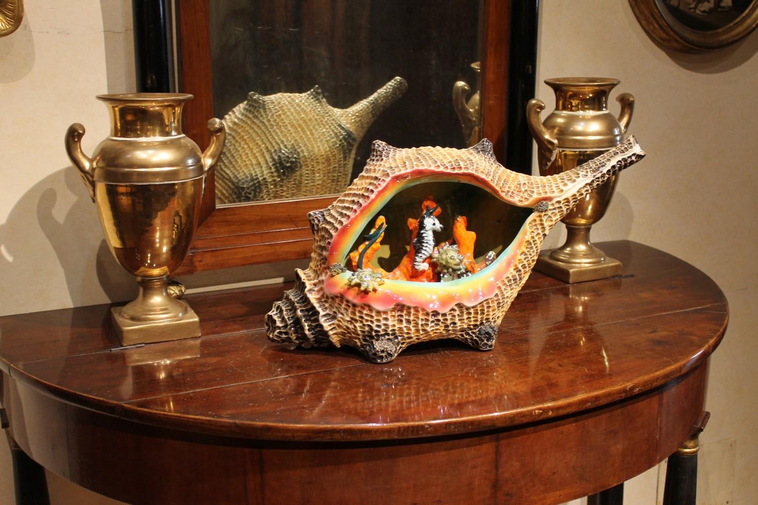 There is all the Italian artisan mastery in this exceptional Mid-Century Modern open worked large Majolica ornament centerpiece in the form of a long shell enriched with crab, seahorse and red coral perfectly shaped inside it. Looking at this