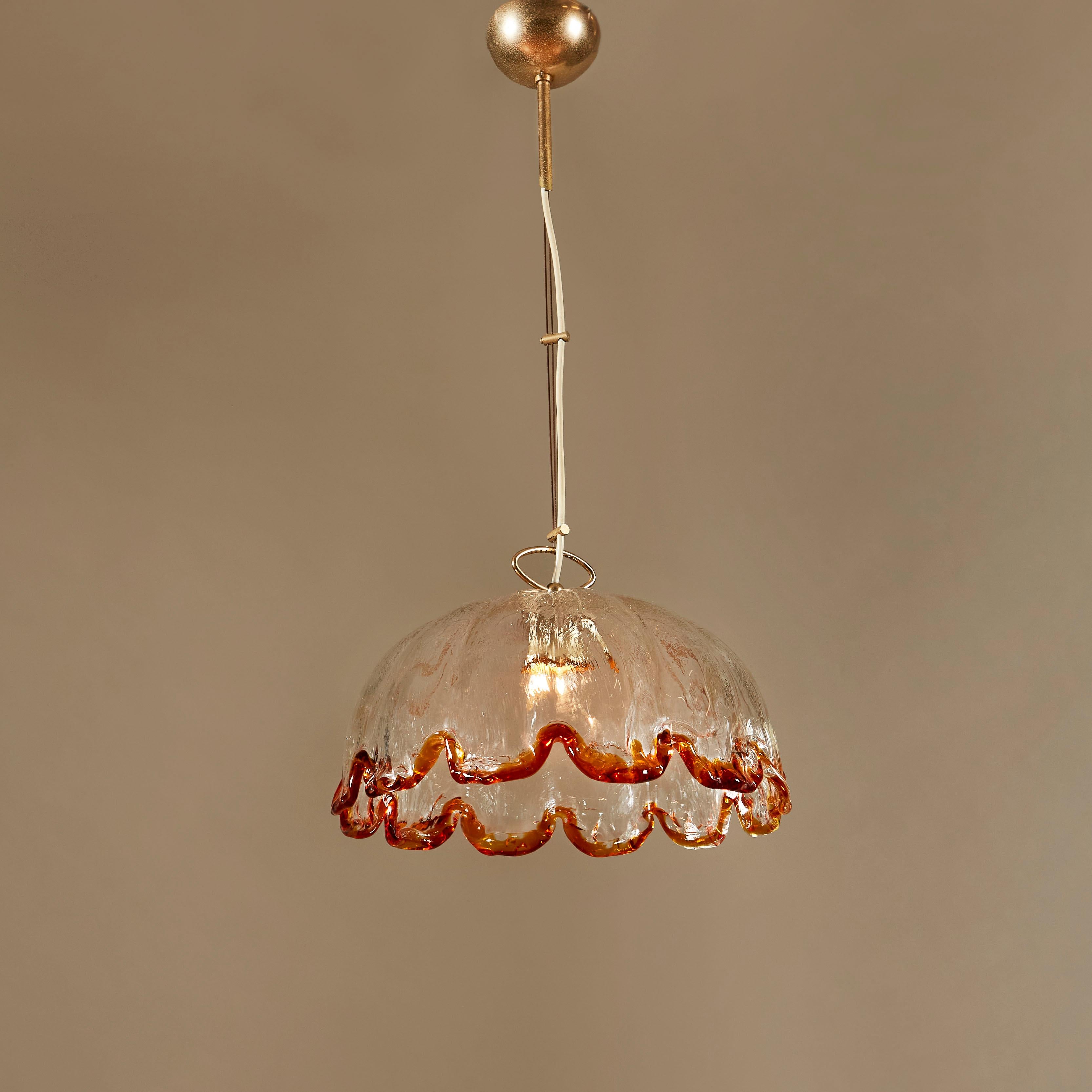 Large beautifully shaped chandelier by the prestigious Murano glass company ‘La Murrina”. Glass shows the original stamp. Thick textured clear glass with rich amber colour to he fluted edge. Decorative brass hardware.