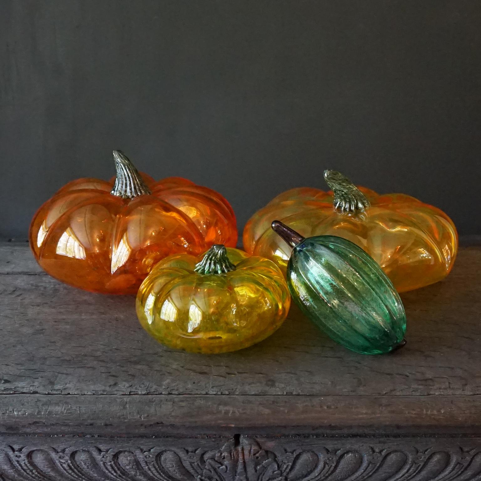 Fantastic vintage 1970s-1980s pumpkins, also know as gourds, in Italian Murano and Swedisch Kosta Boda heavy mouth blown glass. 
Large life size pumpkins in orange, yellow and green glass.
The three large orange-yellowish pumpkins are very pretty