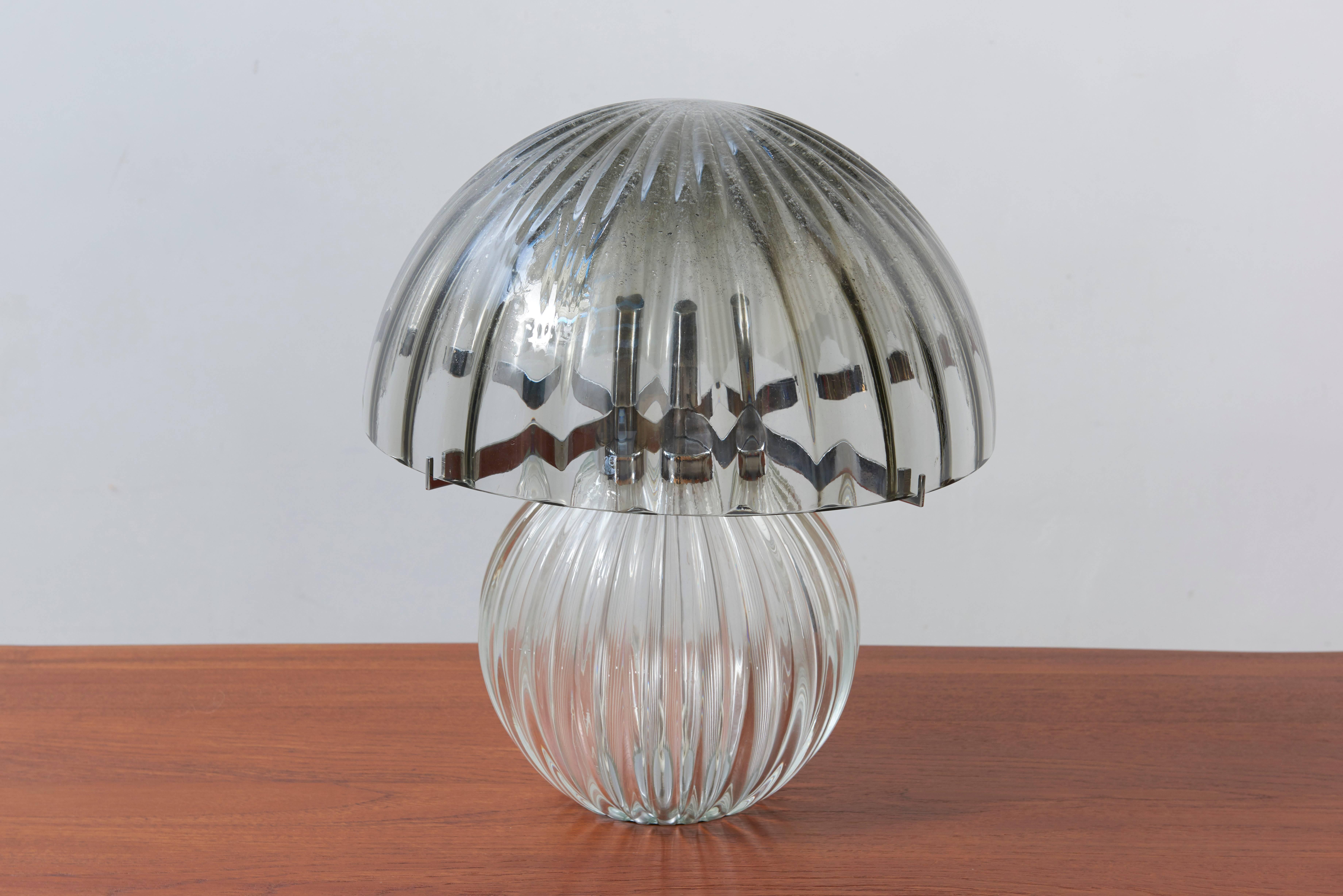 Excellent and rare mushroom table lamp in smoked glass by Murano glass Manufacture. 
The large handblown glass shade and body with their optical cast create a lovely light effect. 

The stylish and clean elegance of this lamp suits many