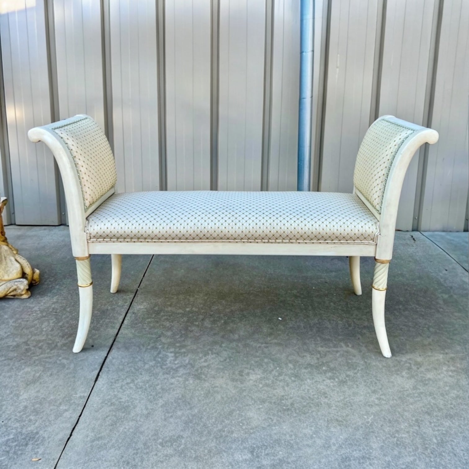 This is a 1970s Italian neoclassical style upholstered bench. The upholstery is vintage and in good condition. The painted frame is ivory with gilt and celadon accents. It is unmarked.