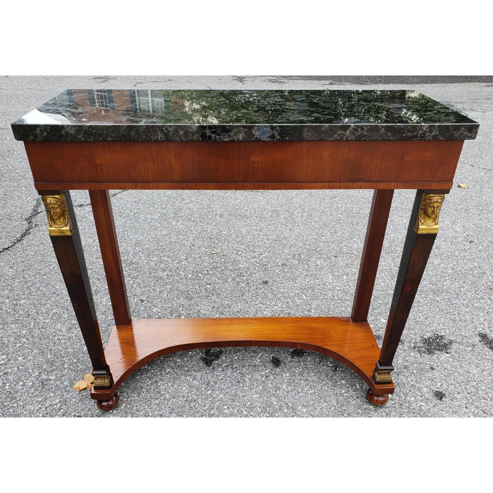 Regency vintage console table or hall table with marble / stone top. Bottom shelf for additional display space. Solid decorative brass human head. Excellent condition. Table 32 inch wide x 12inch in depth x 31 inch in height. Stone top comes loose