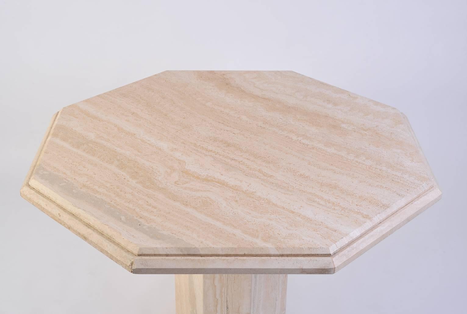 An octagonal travertine dining table
The octagonal base supporting a beveled edges top, 
Italy, circa 1975.