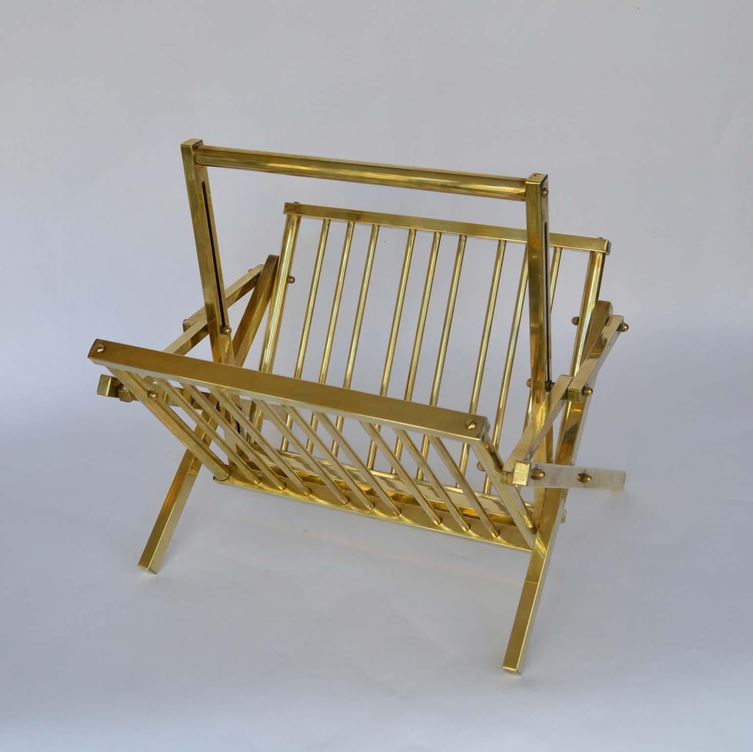Stylish midcentury magazine rack in polished tubular brass. 
It is collapsable, when folded it measures 49x42x6 cm.