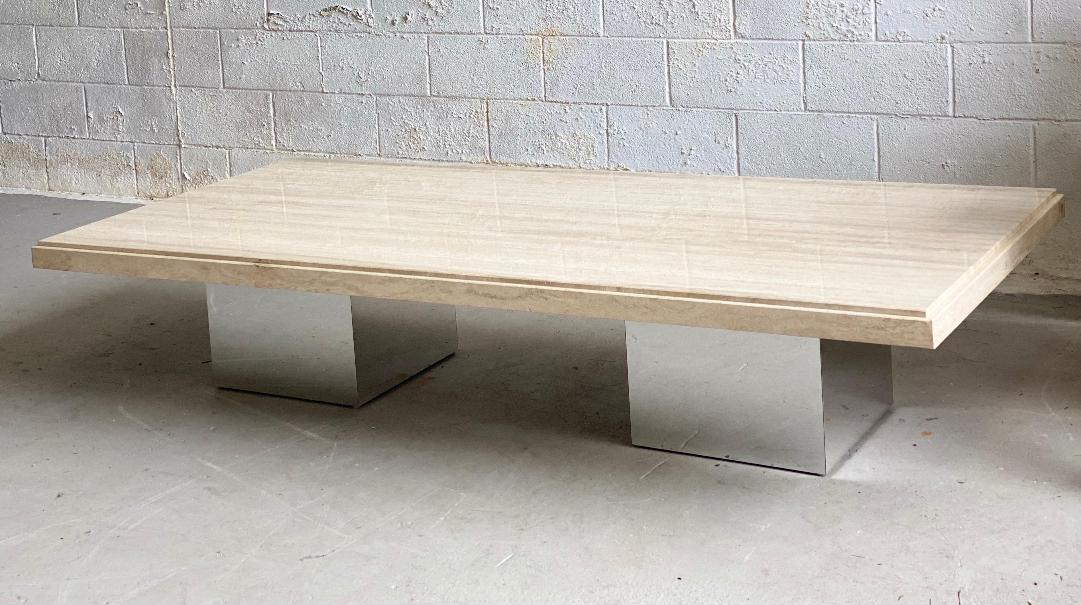 We are very pleased to offer a classic, monumental coffee table, circa the 1970s. This coffee table is a beautiful balance of simple forms and finishes. Two square bases, with a metal chrome finish, make a stable support for a wide and heavy,