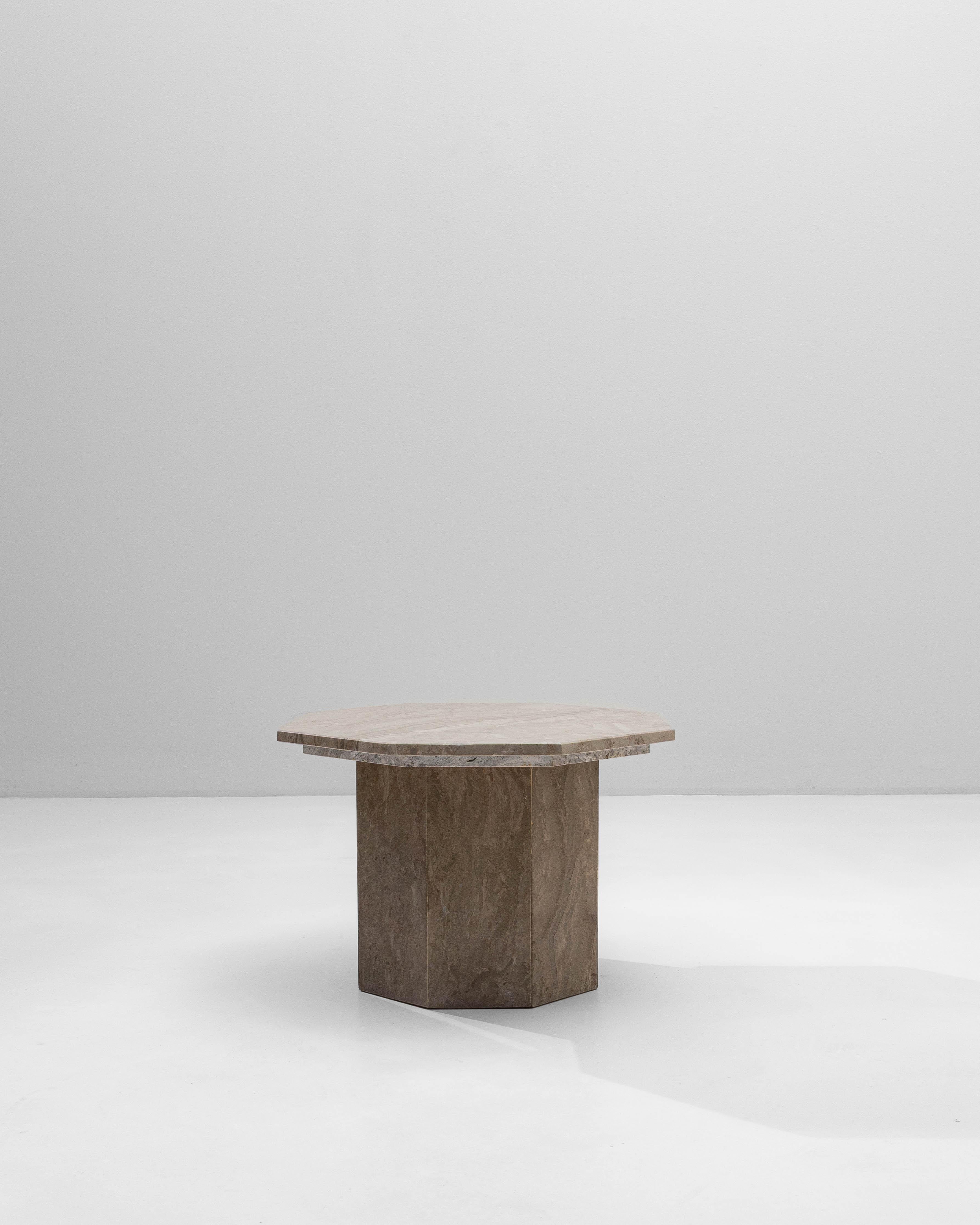 This 1970s Italian postmodern octagonal marble pedestal table exemplifies the bold geometry and sculptural presence characteristic of the era. Crafted entirely from richly veined marble, the table features an octagonal top with clean, confident